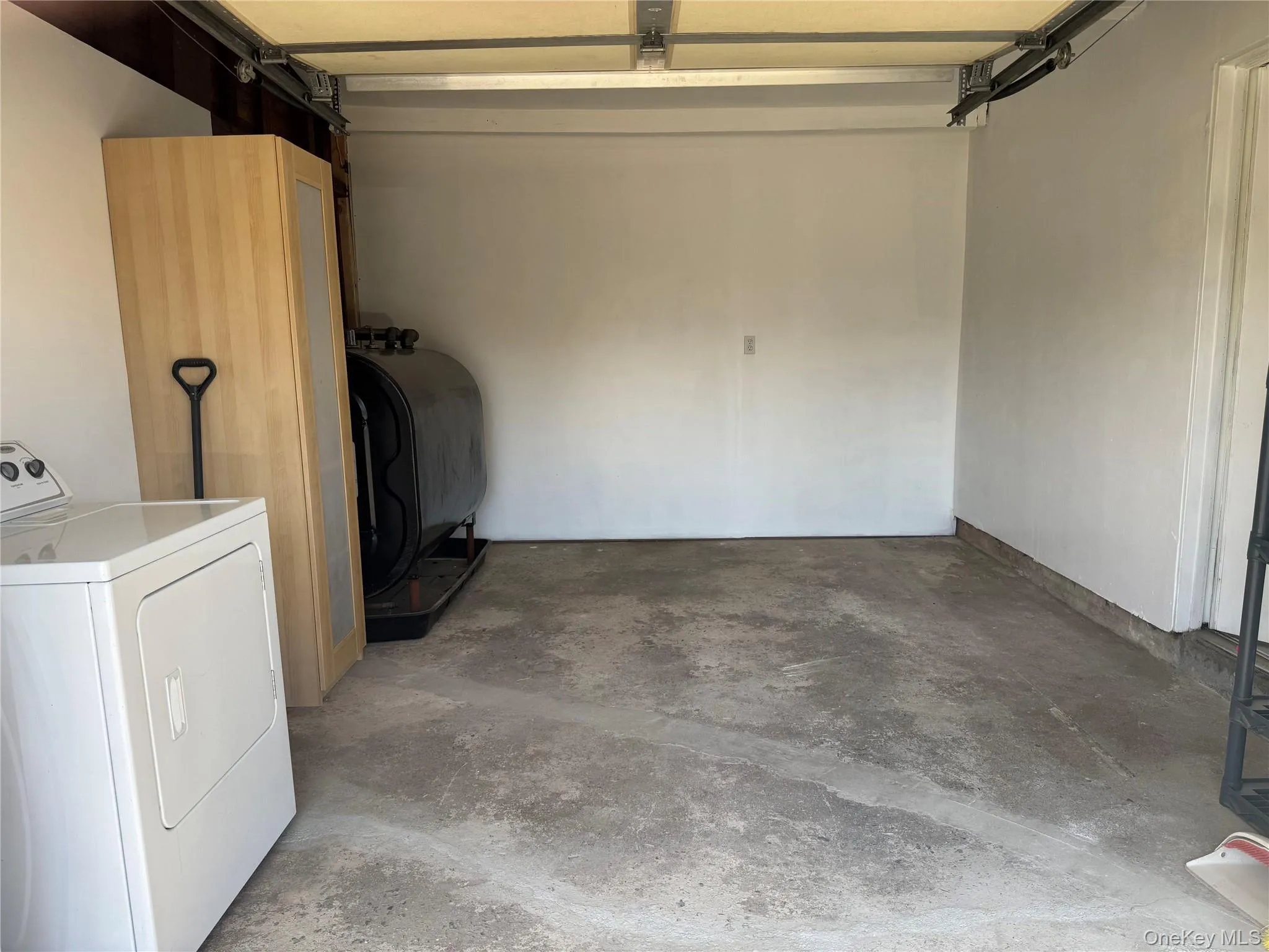 Garage featuring washer / clothes dryer and heating fuel Garage featuring washer / clothes dryer and heating fuel