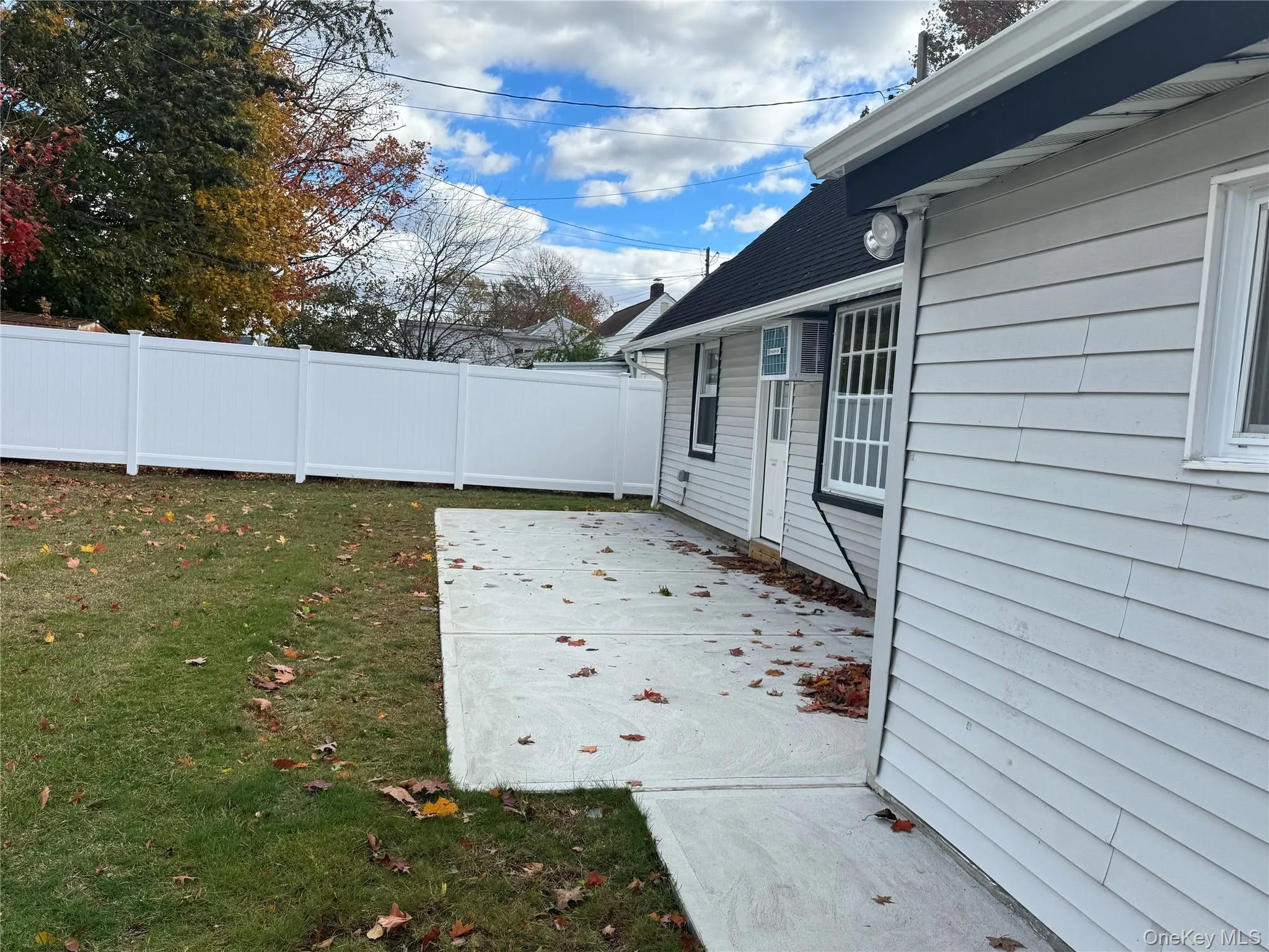 Fenced backyard featuring a patio area Fenced backyard featuring a patio area