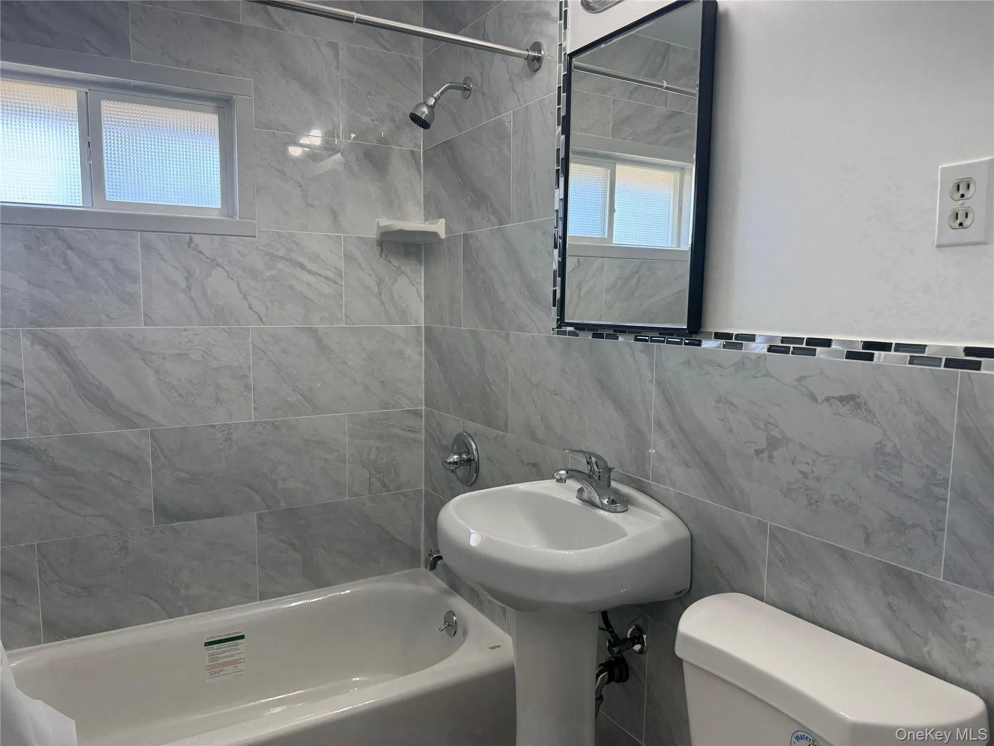 Full bath with shower / washtub combination and tile walls Full bath with shower / washtub combination and tile walls