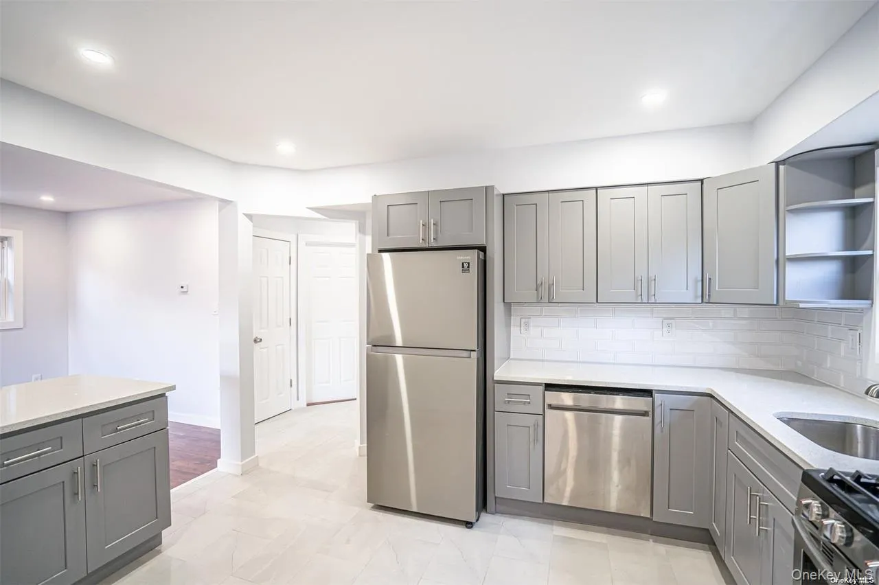 Kitchen featuring open shelves, gray cabinetry, light stone countertops, and recessed lighting Kitchen featuring open shelves, gray cabinetry, light stone countertops, and recessed lighting