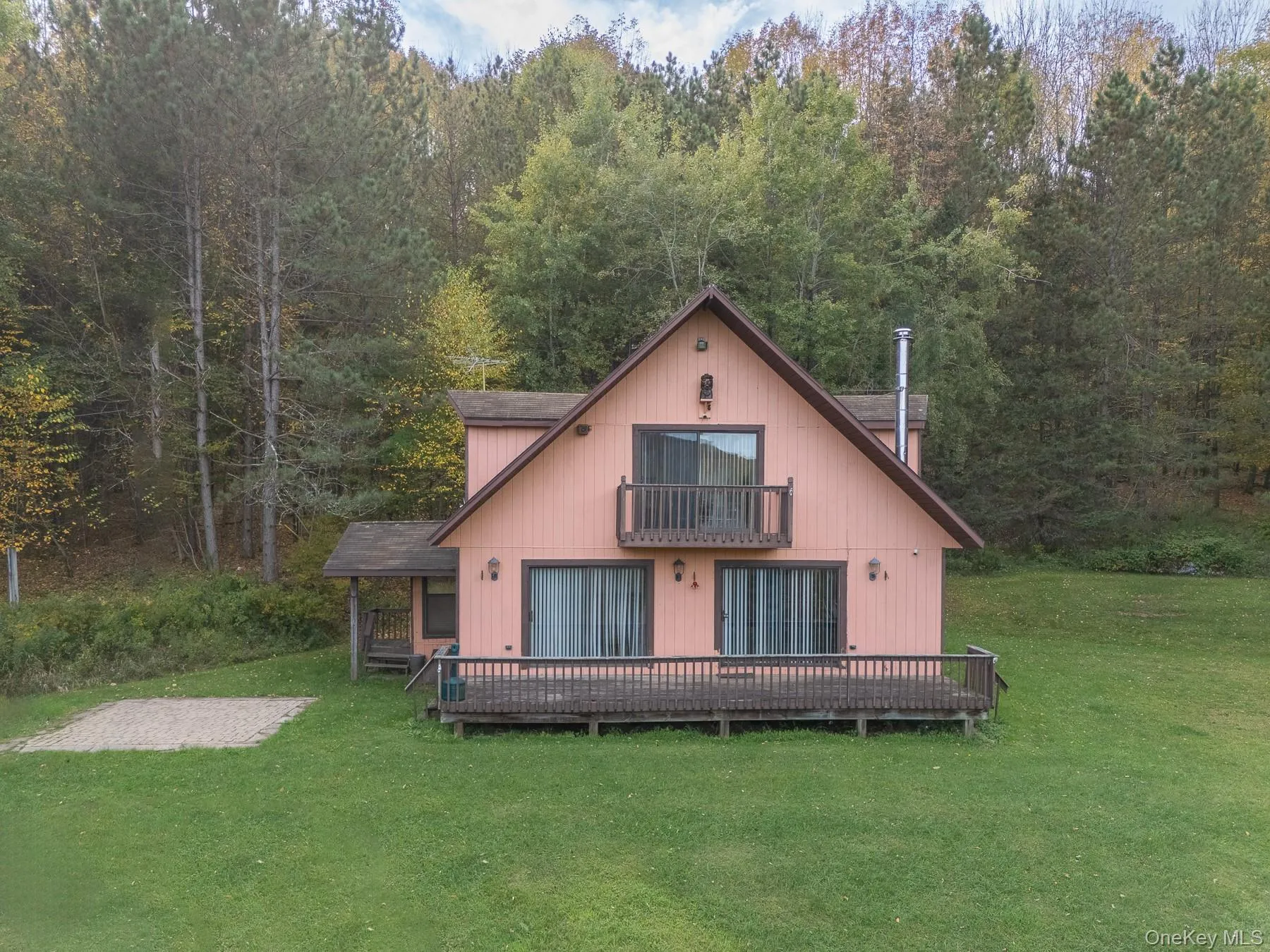 Rear view of house featuring a yard, a balcony, and a deck Rear view of house featuring a yard, a balcony, and a deck