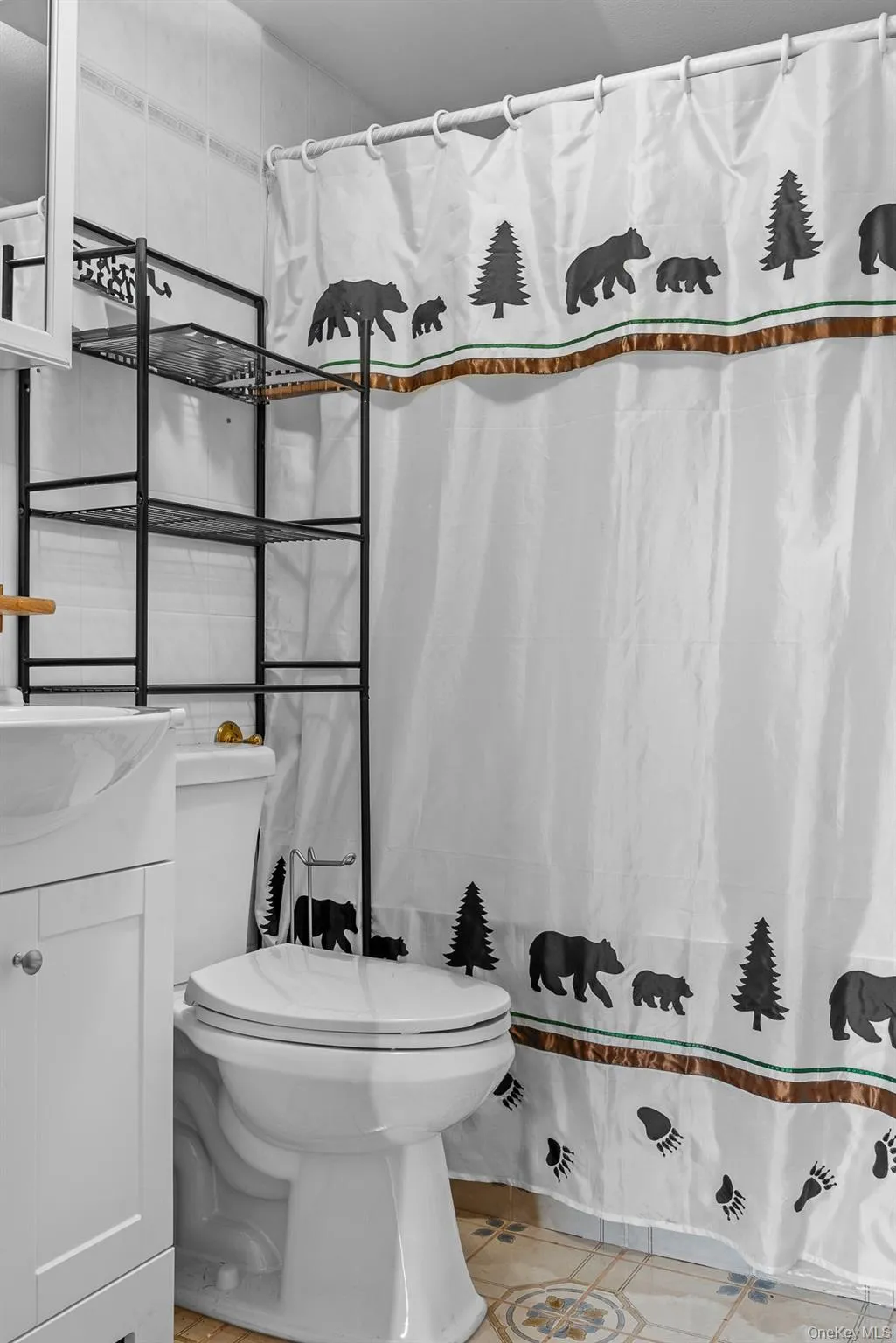 Bathroom with vanity, light tile patterned floors, and a shower with curtain Bathroom with vanity, light tile patterned floors, and a shower with curtain