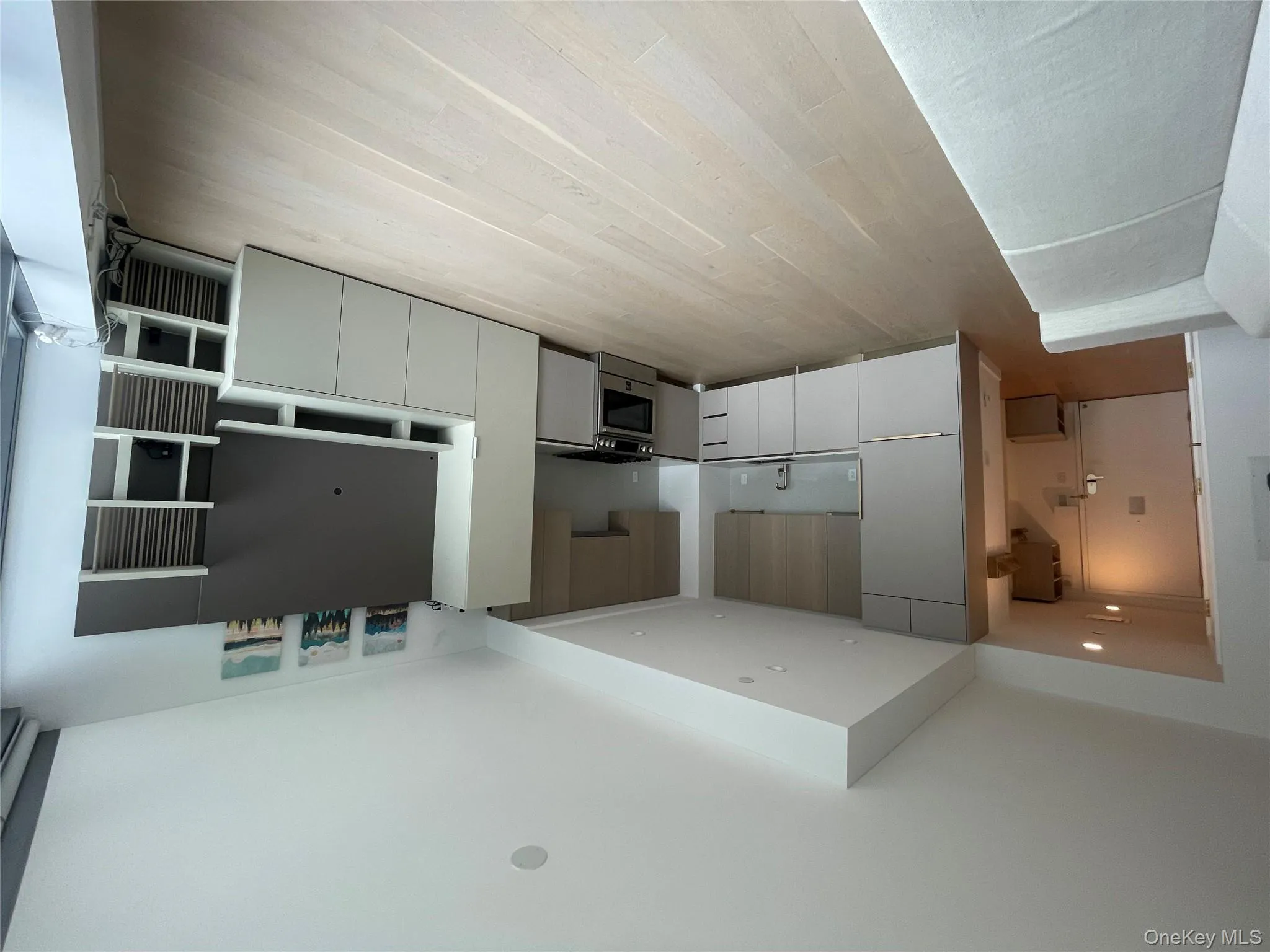 Unfurnished living room with light wood-type flooring and recessed lighting Unfurnished living room with light wood-type flooring and recessed lighting