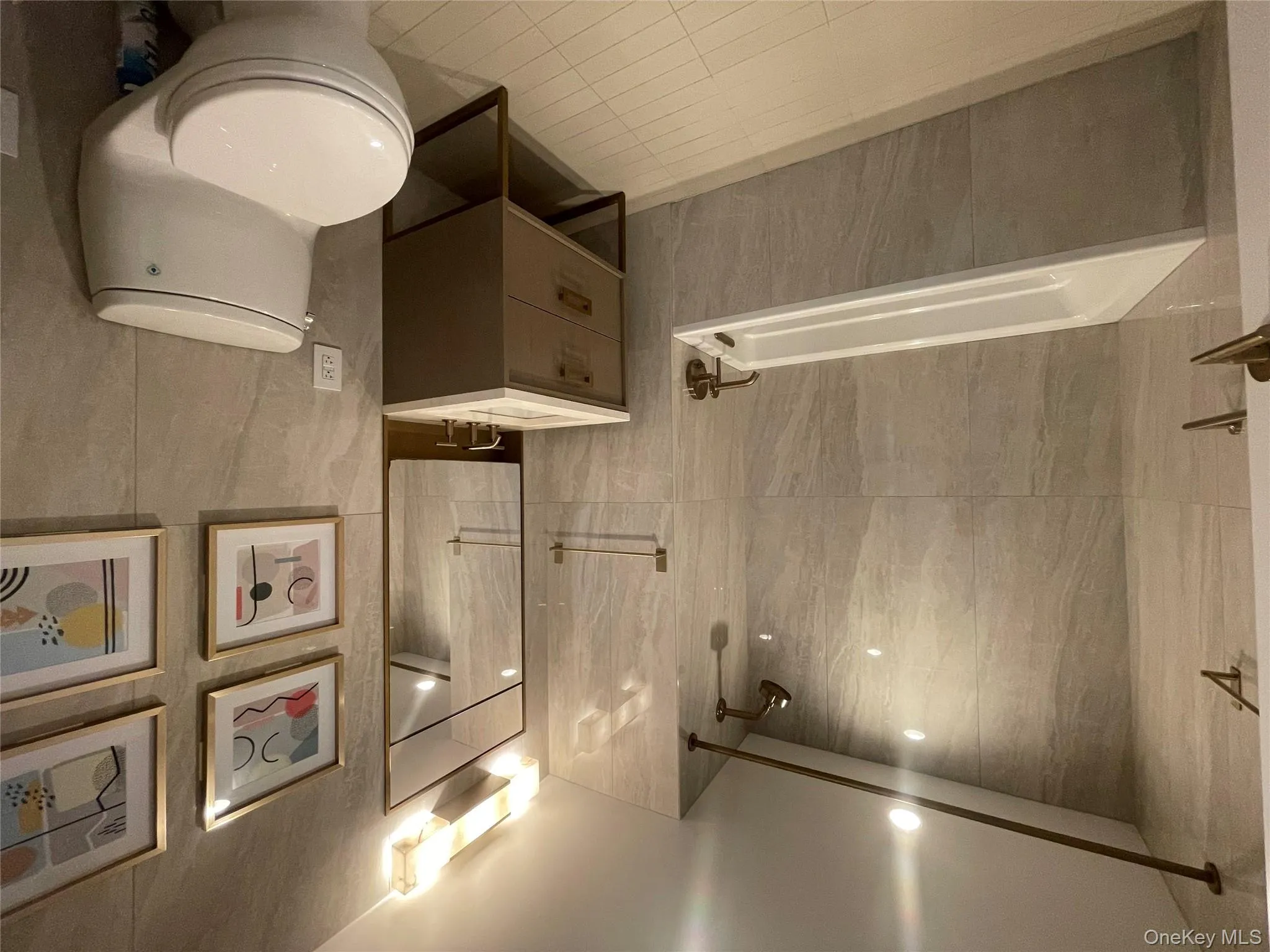 Bathroom with tiled shower / bath combo, vanity, light tile patterned flooring, and tile walls Bathroom with tiled shower / bath combo, vanity, light tile patterned flooring, and tile walls