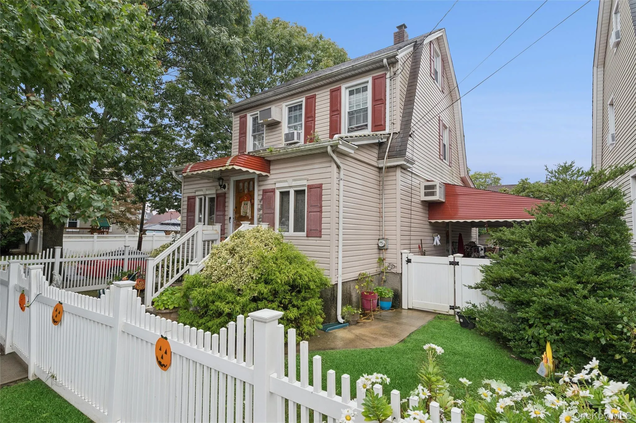 View of front of house featuring a fenced front yard, a gate, and a chimney View of front of house featuring a fenced front yard, a gate, and a chimney
