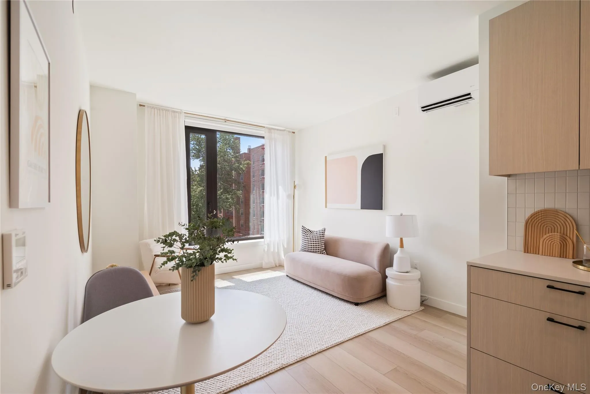 Dining room with light wood-type flooring and a wall mounted air conditioner Dining room with light wood-type flooring and a wall mounted air conditioner