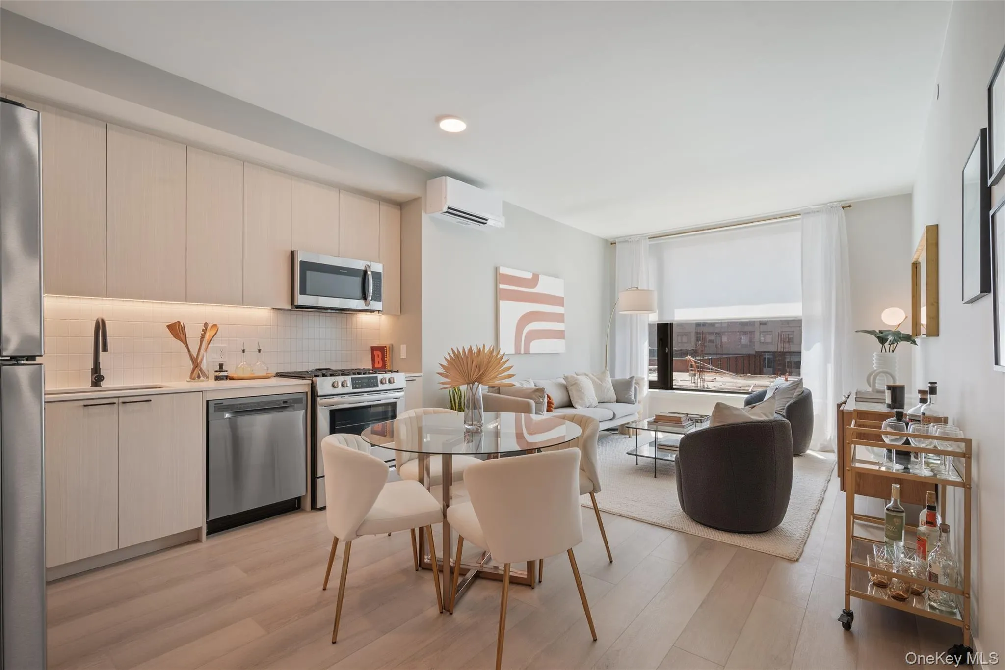 Kitchen featuring modern cabinets, appliances with stainless steel finishes, decorative backsplash, light wood-type flooring, and recessed lighting Kitchen featuring modern cabinets, appliances with stainless steel finishes, decorative backsplash, light wood-type flooring, and recessed lighting