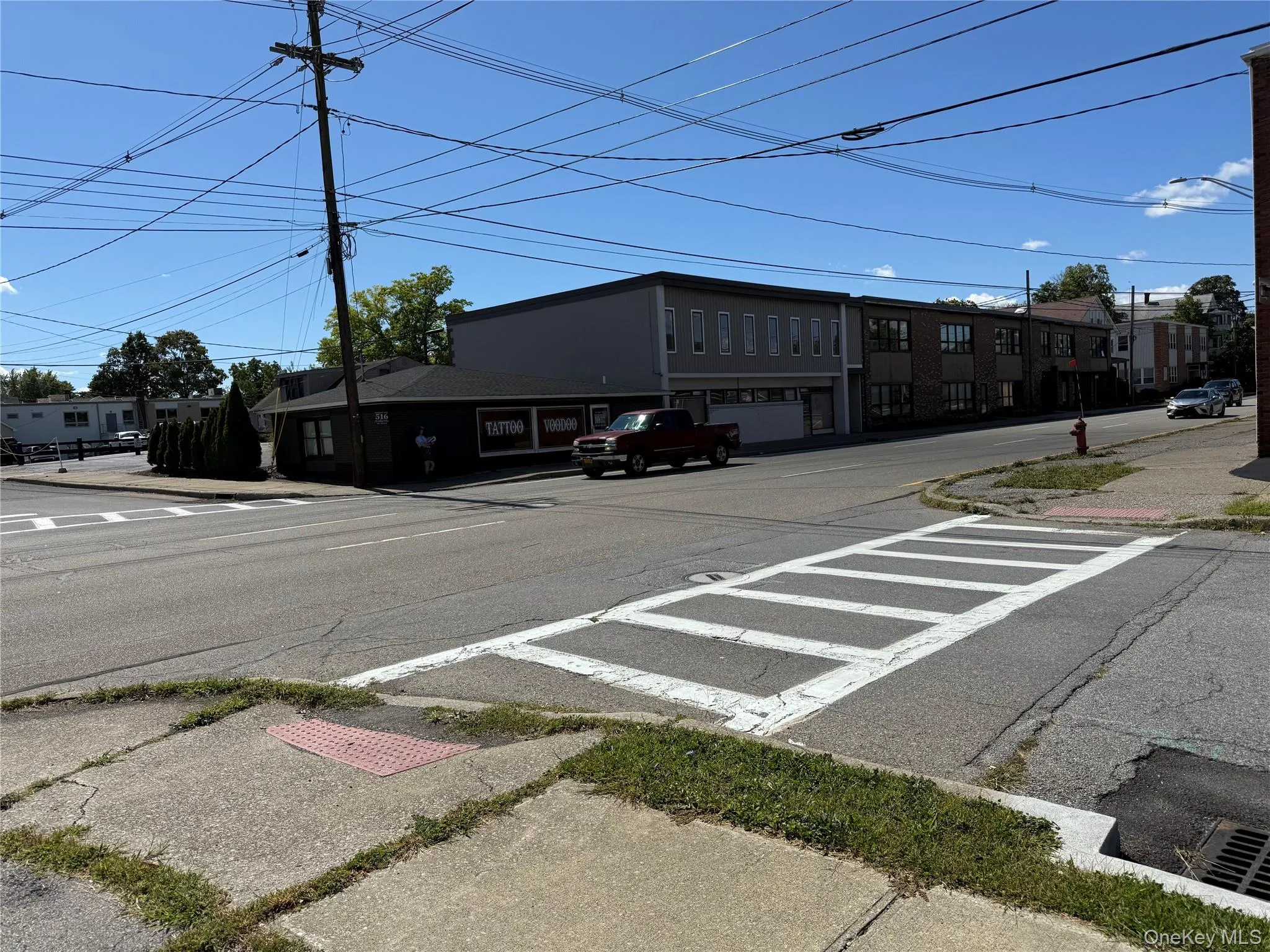 High visibilty Corner lot. View of asphalt road with sidewalks, curbs, and street lighting High visibilty Corner lot. View of asphalt road with sidewalks, curbs, and street lighting