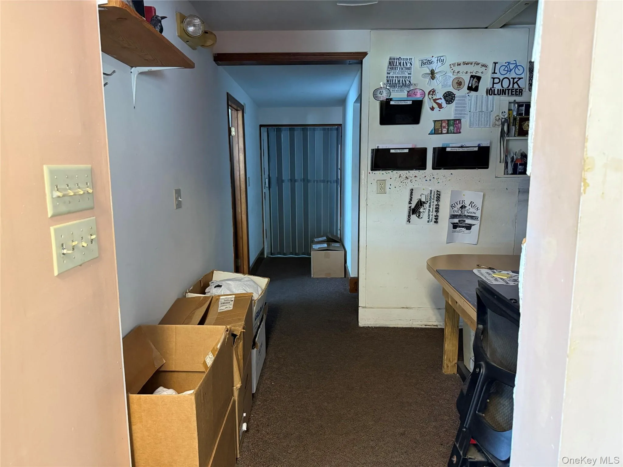 Corridor featuring dark colored carpet to Production Room Corridor featuring dark colored carpet to Production Room
