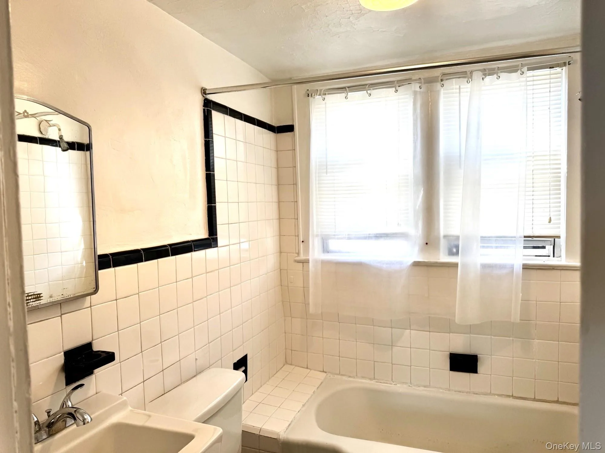 Bathroom with tile walls and shower / tub combination Bathroom with tile walls and shower / tub combination