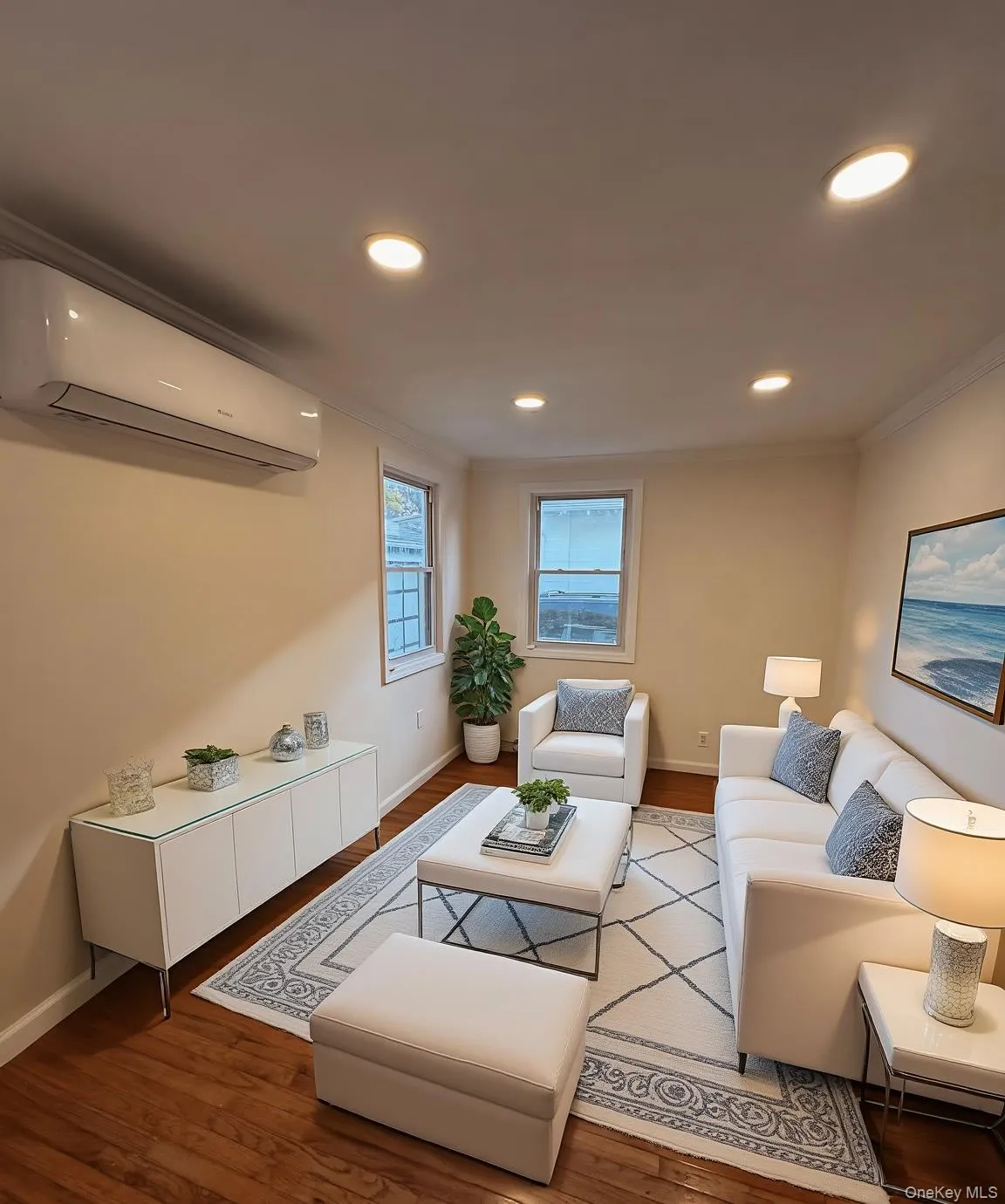 Living area featuring a wall mounted air conditioner, wood finished floors, recessed lighting, and crown molding Living area featuring a wall mounted air conditioner, wood finished floors, recessed lighting, and crown molding