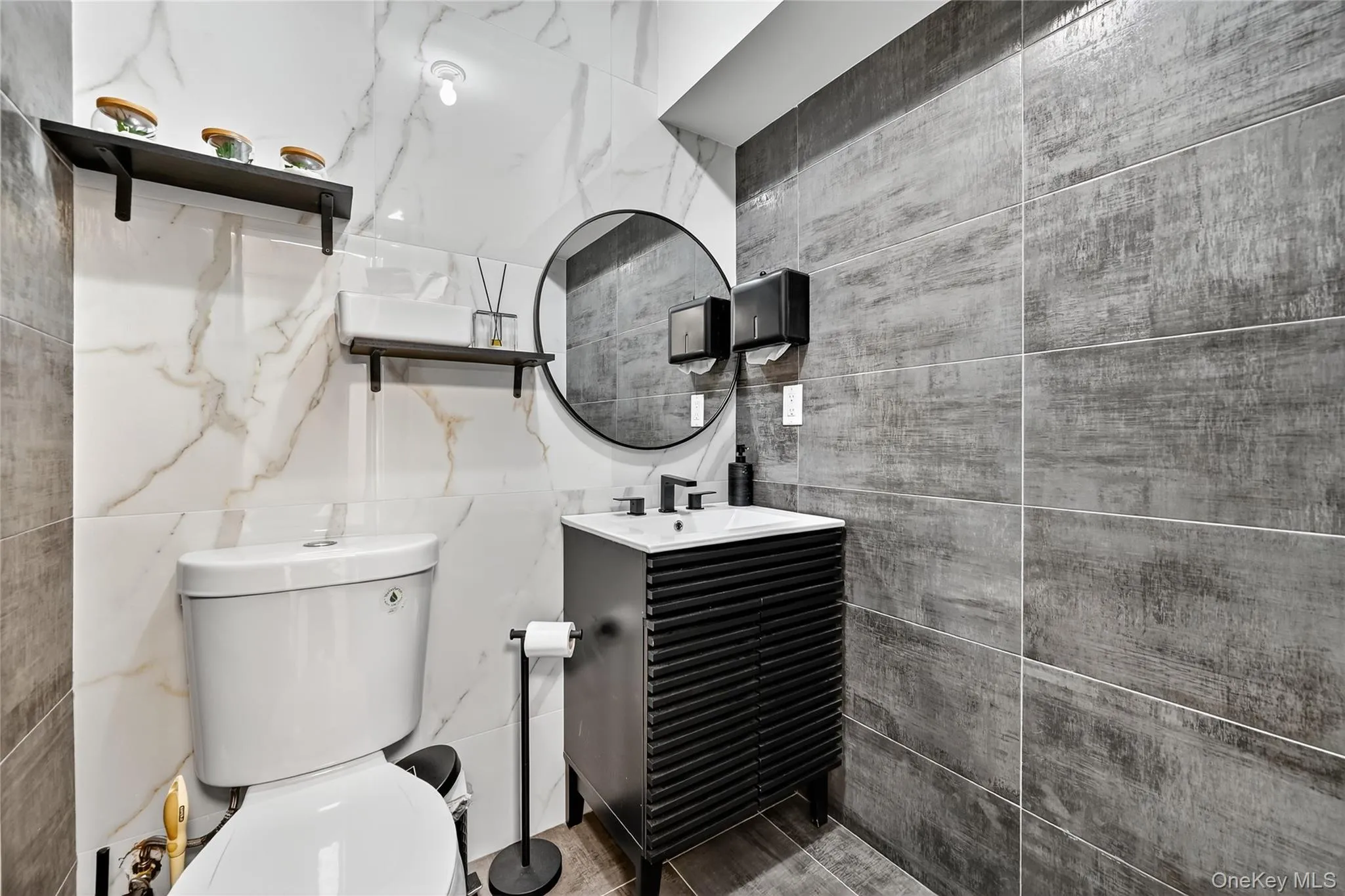 Bathroom featuring vanity and tile walls Bathroom featuring vanity and tile walls