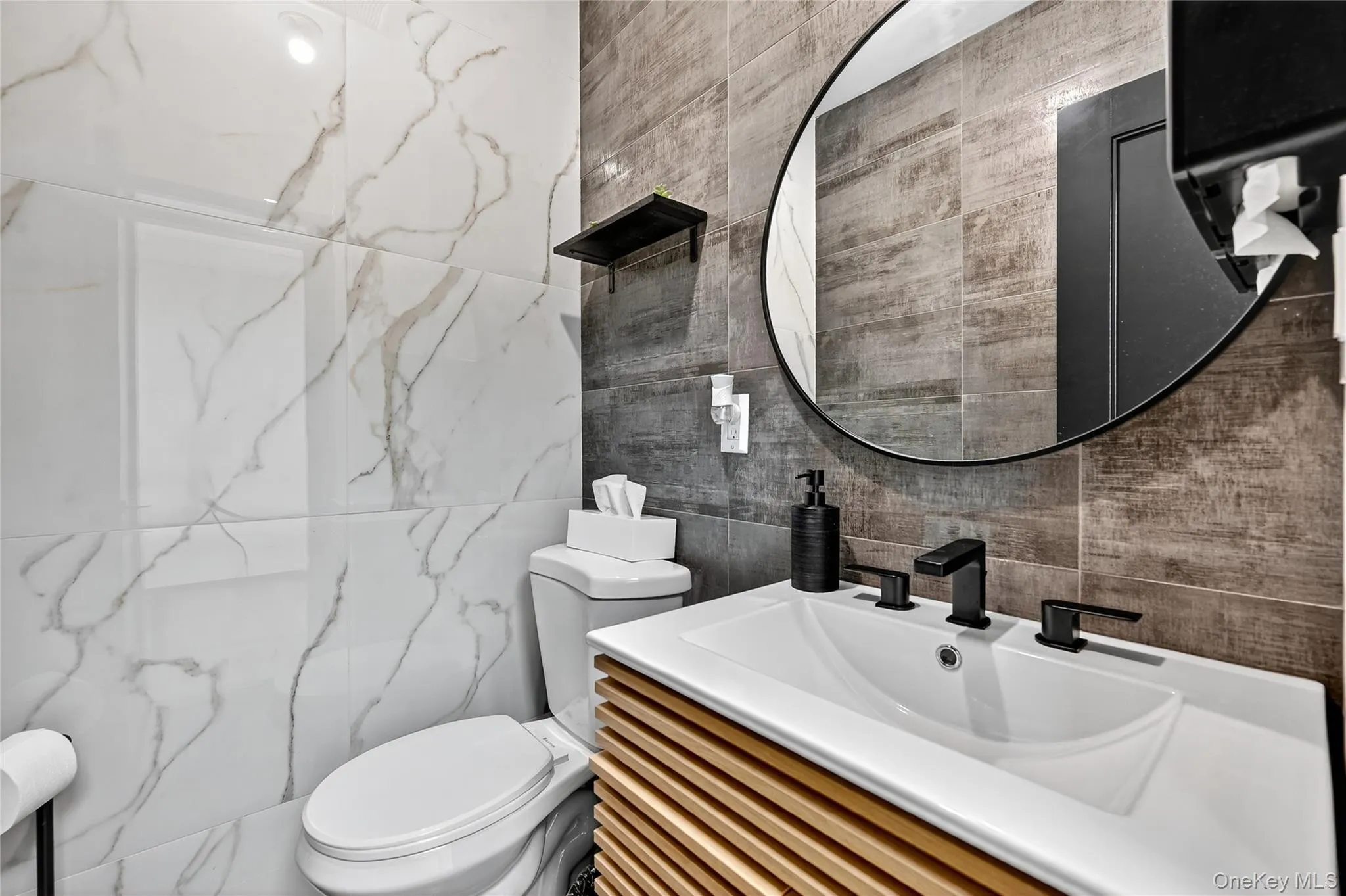 Half bathroom with vanity and tile walls Half bathroom with vanity and tile walls