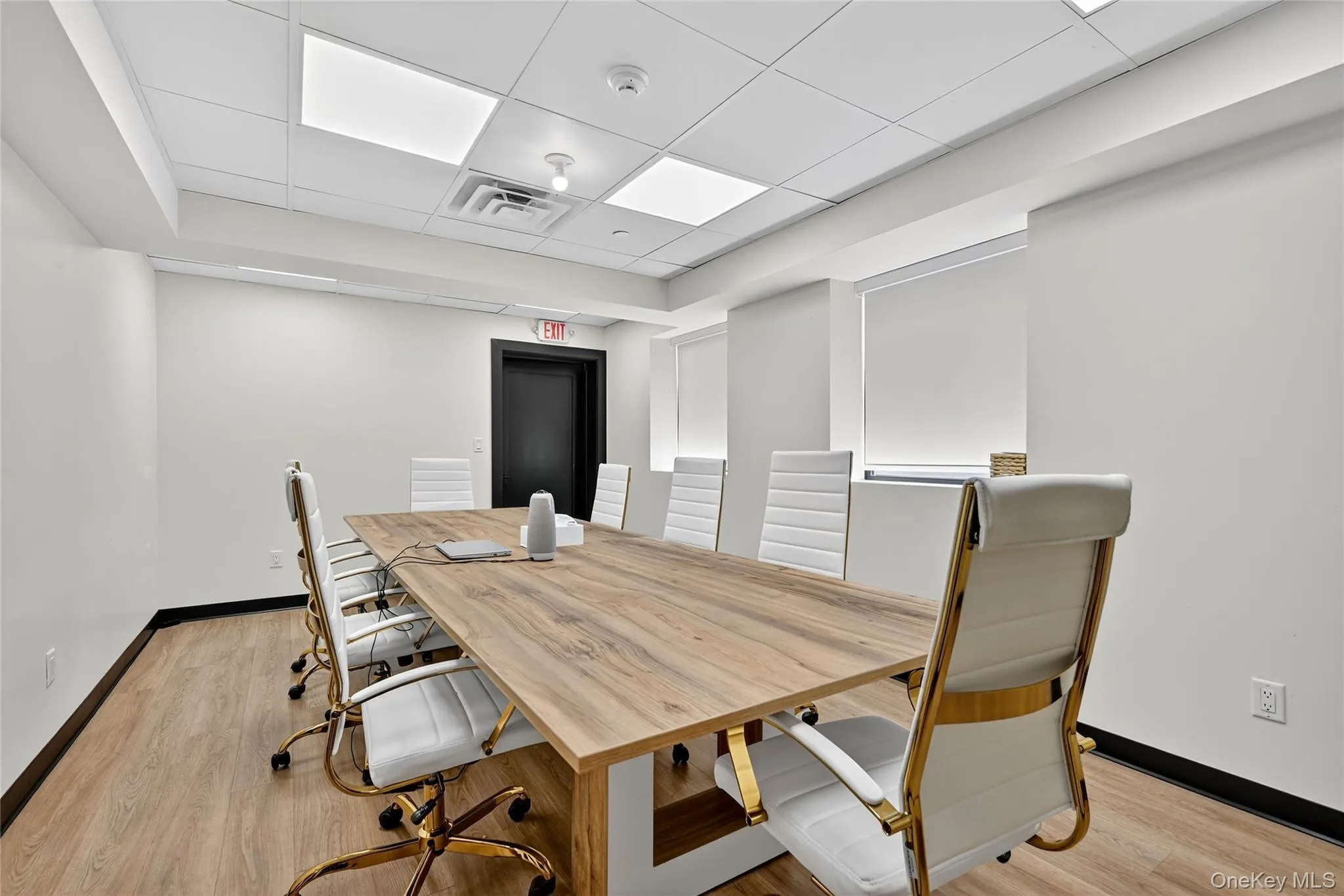 Dining area with a drop ceiling and light wood-style flooring Dining area with a drop ceiling and light wood-style flooring