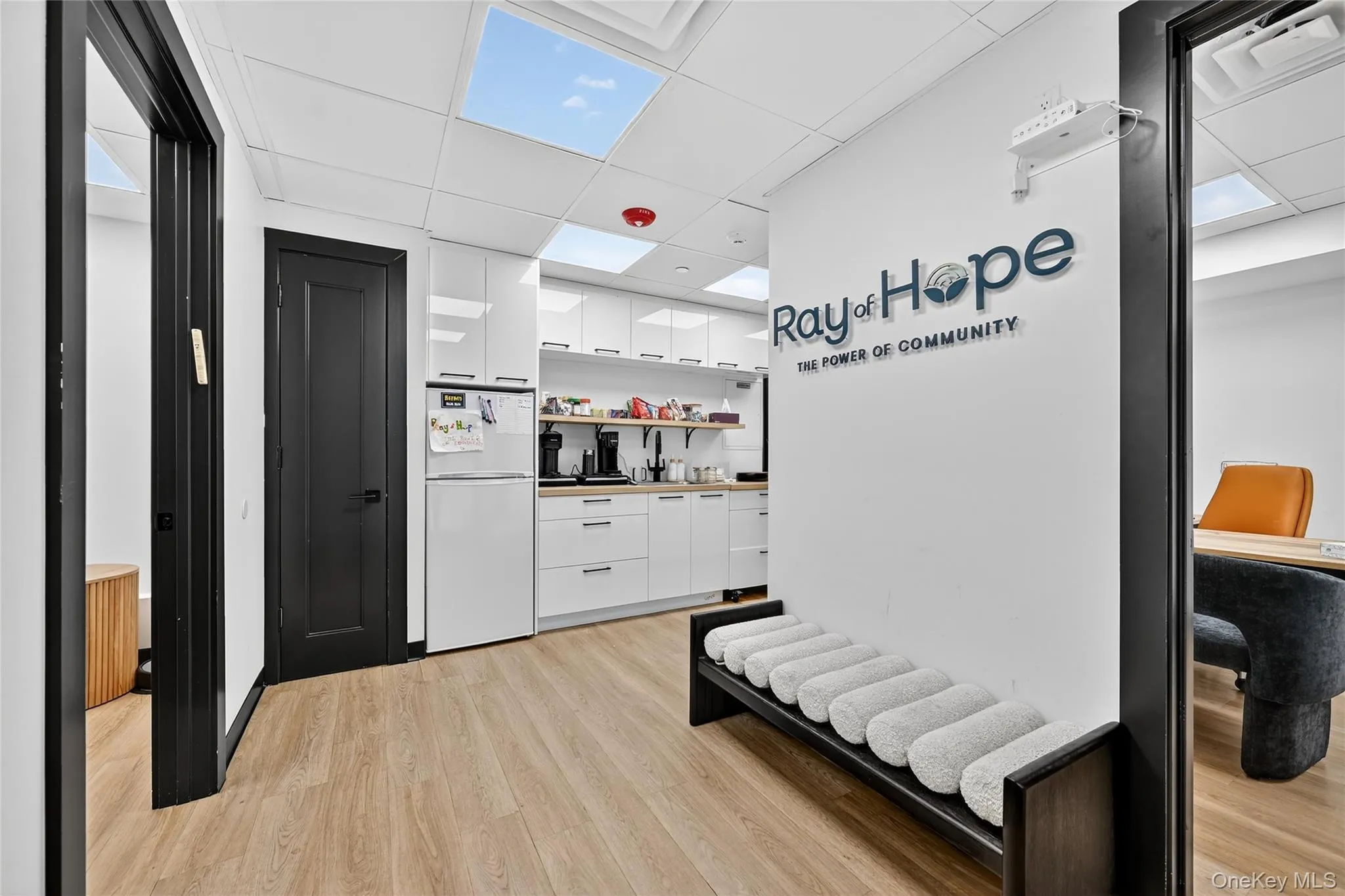 Hall with a drop ceiling and light wood finished floors Hall with a drop ceiling and light wood finished floors