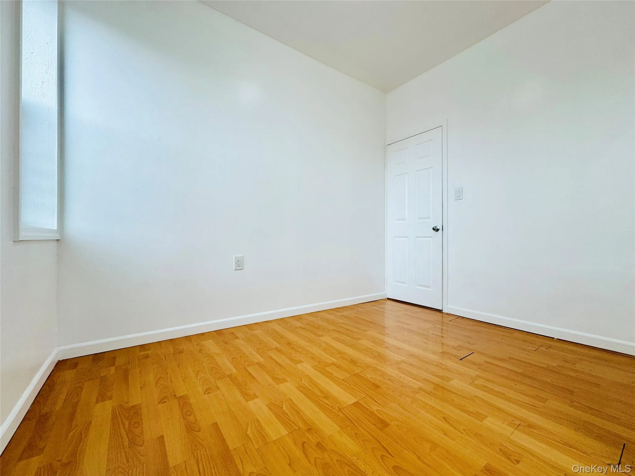 Empty room featuring light wood-type flooring and baseboards Empty room featuring light wood-type flooring and baseboards