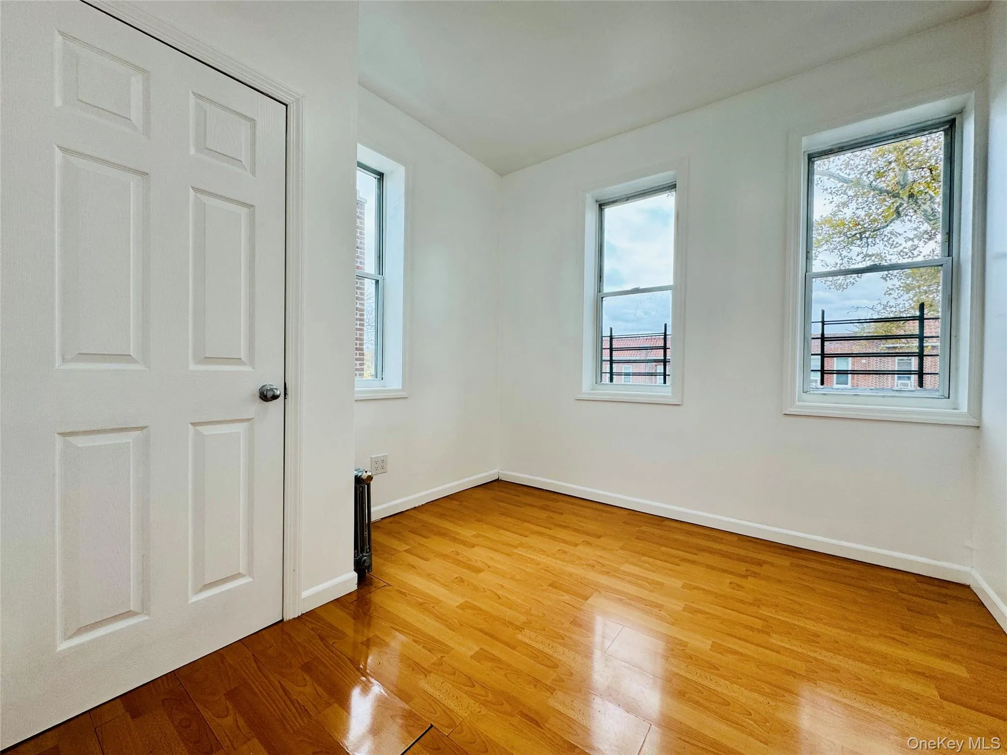 Unfurnished bedroom with light wood finished floors and baseboards Unfurnished bedroom with light wood finished floors and baseboards