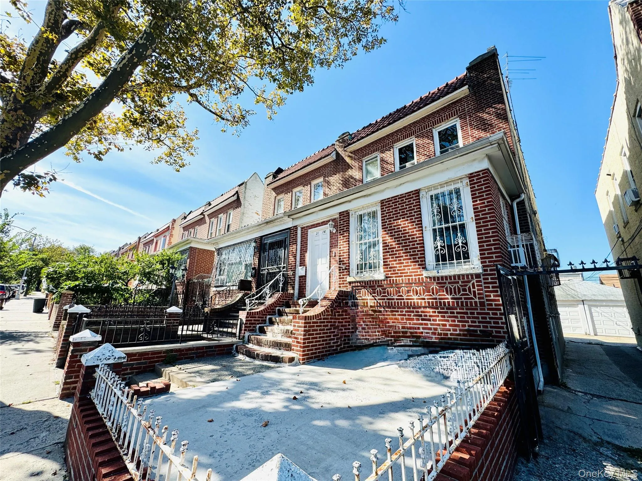 Traditional-style home with brick siding and a patio Traditional-style home with brick siding and a patio