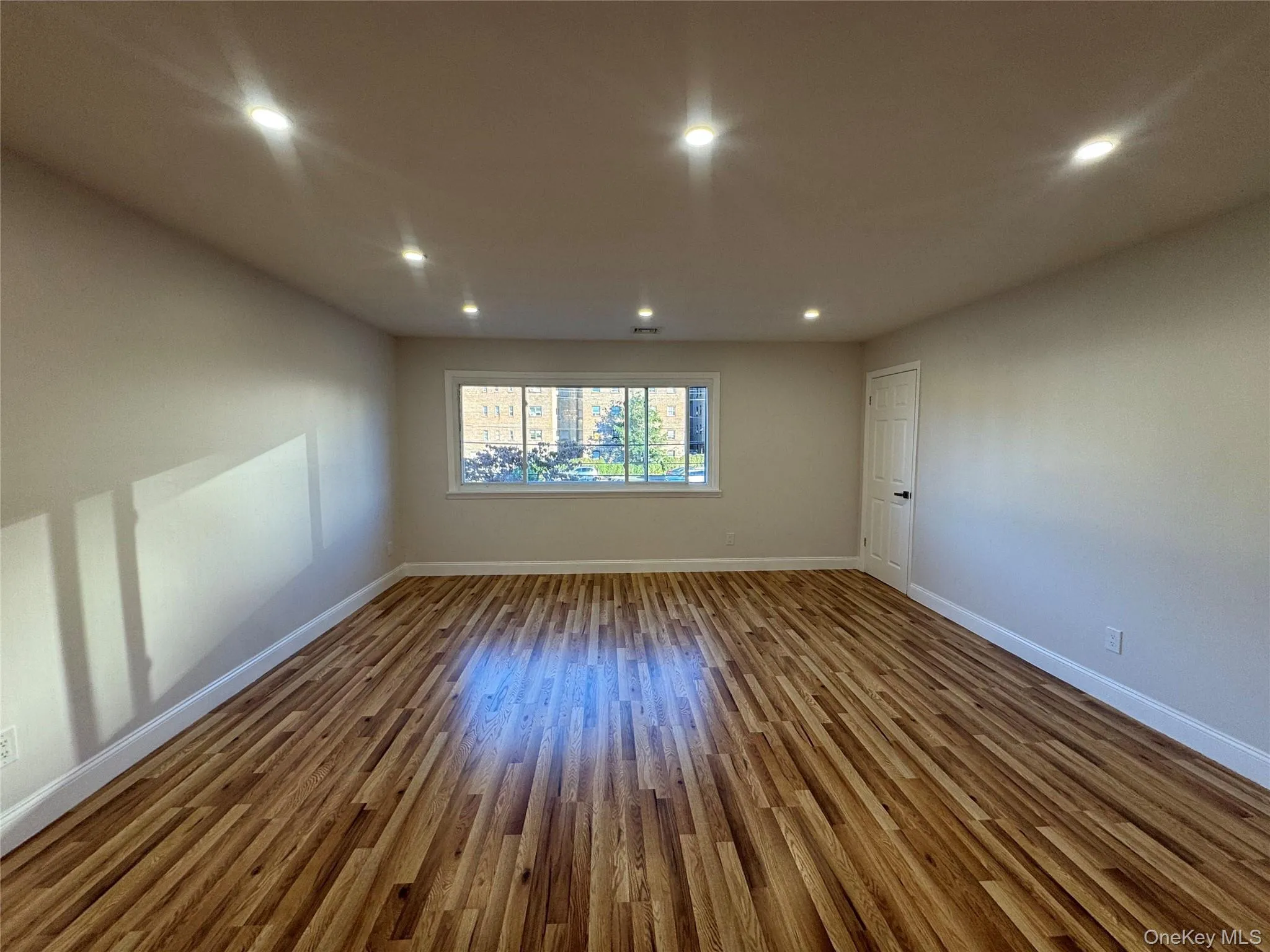 Spare room featuring wood finished floors and recessed lighting Spare room featuring wood finished floors and recessed lighting