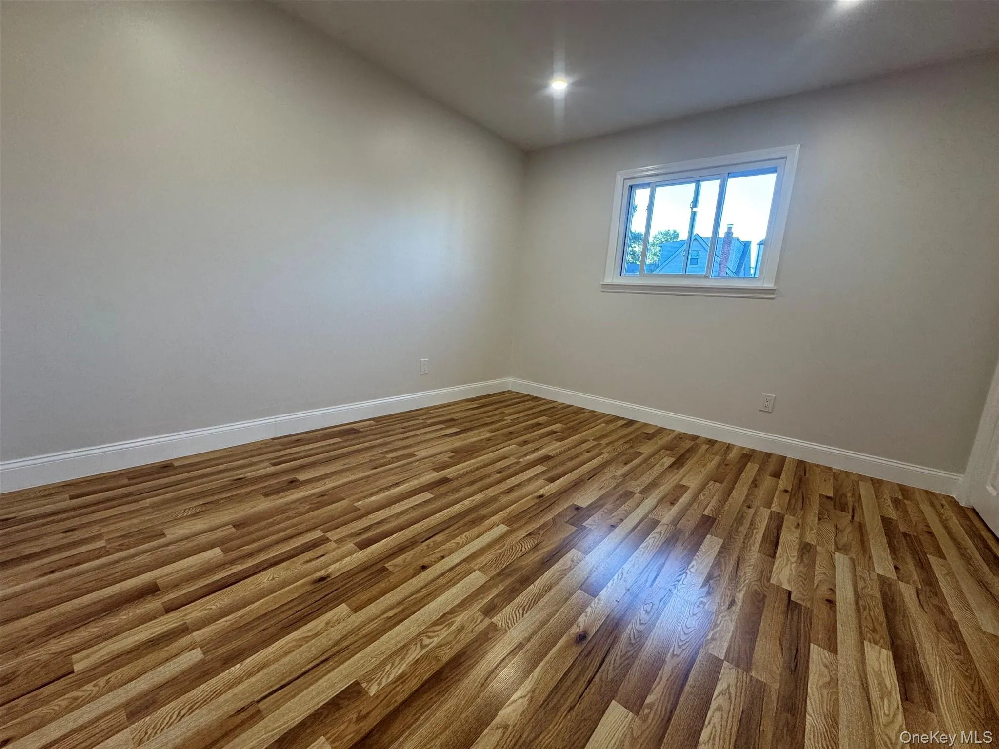 Unfurnished room with light wood-style floors and recessed lighting Unfurnished room with light wood-style floors and recessed lighting