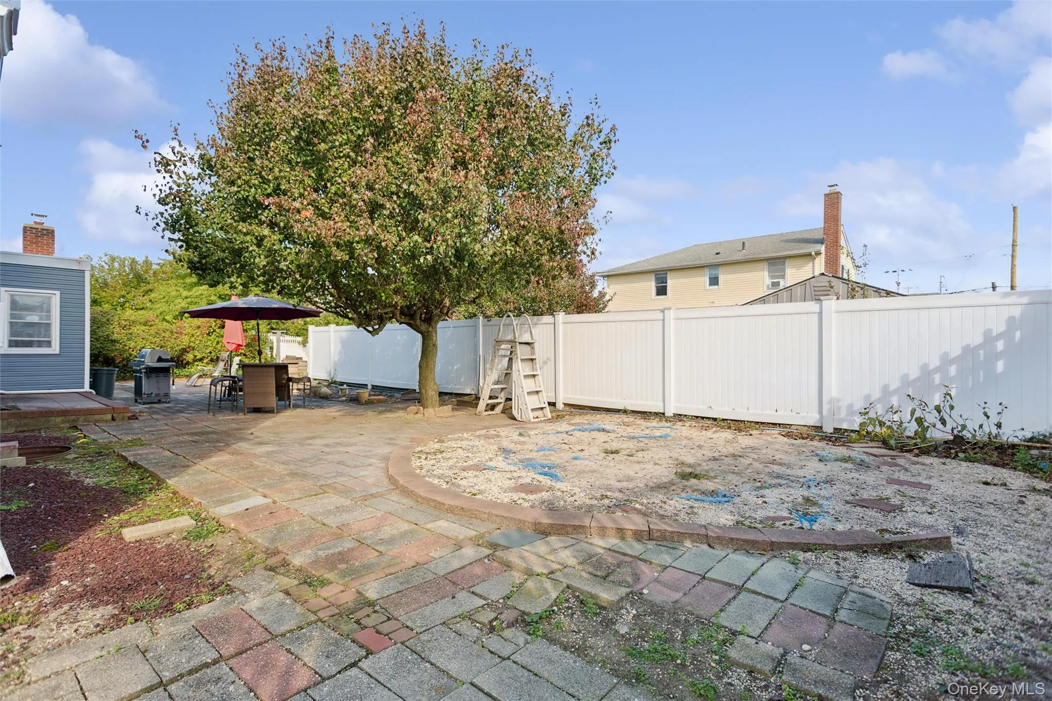 Fenced backyard with a patio and area for grilling Fenced backyard with a patio and area for grilling
