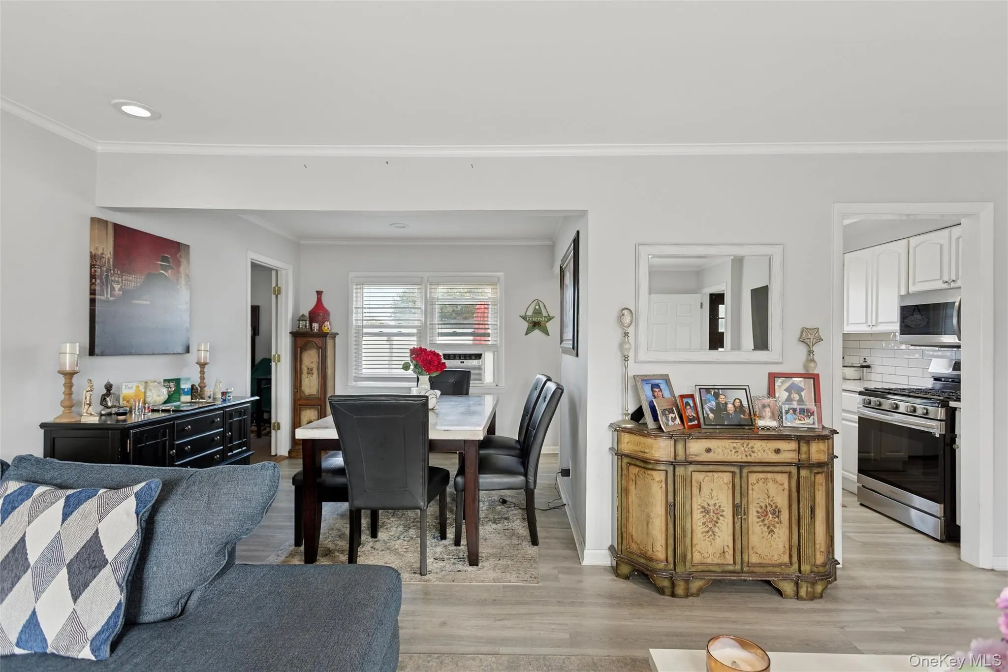 Dining room featuring ornamental molding, light wood-style flooring, and recessed lighting Dining room featuring ornamental molding, light wood-style flooring, and recessed lighting