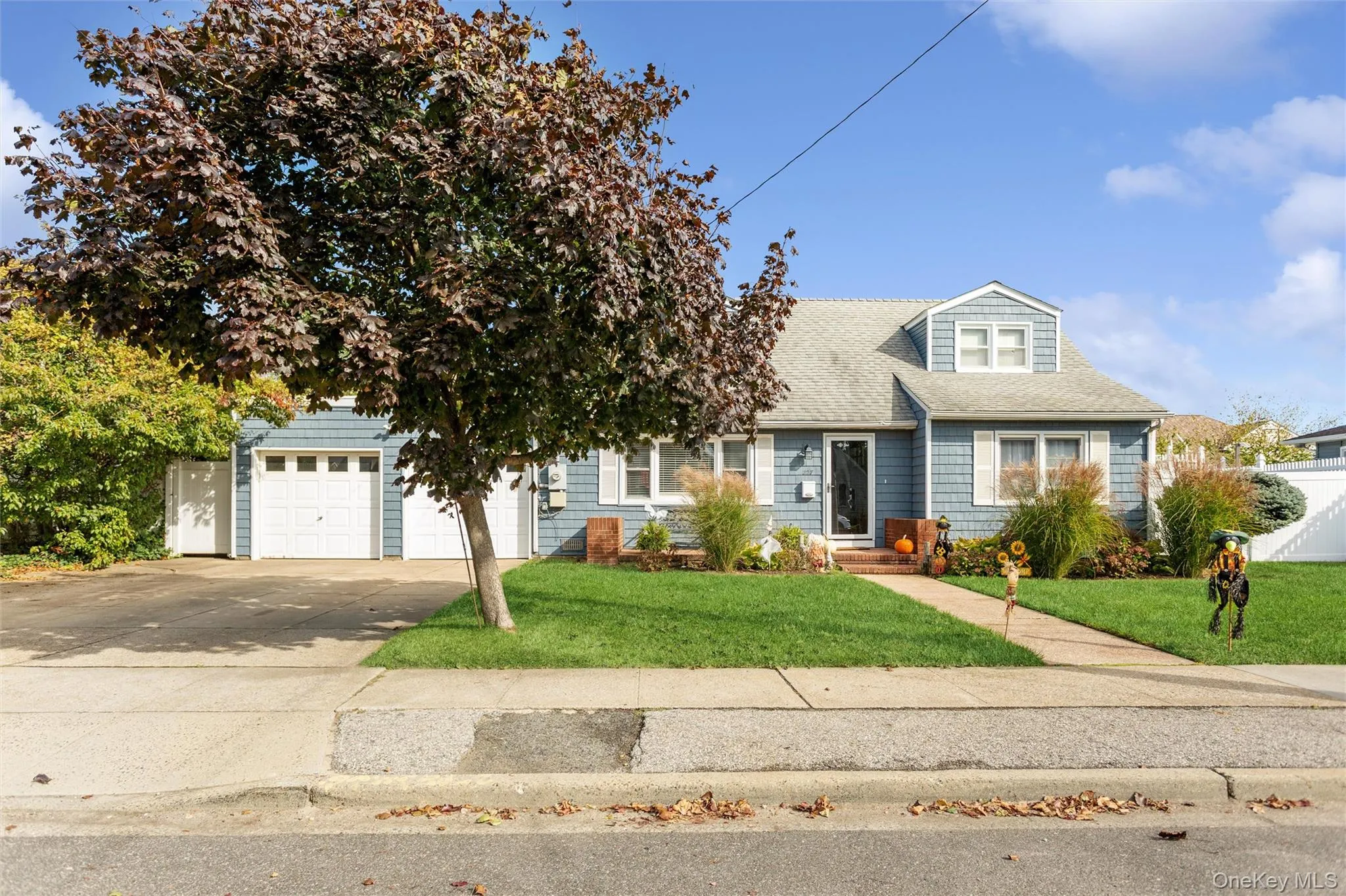 View of front of property with driveway, roof with shingles, and a garage View of front of property with driveway, roof with shingles, and a garage