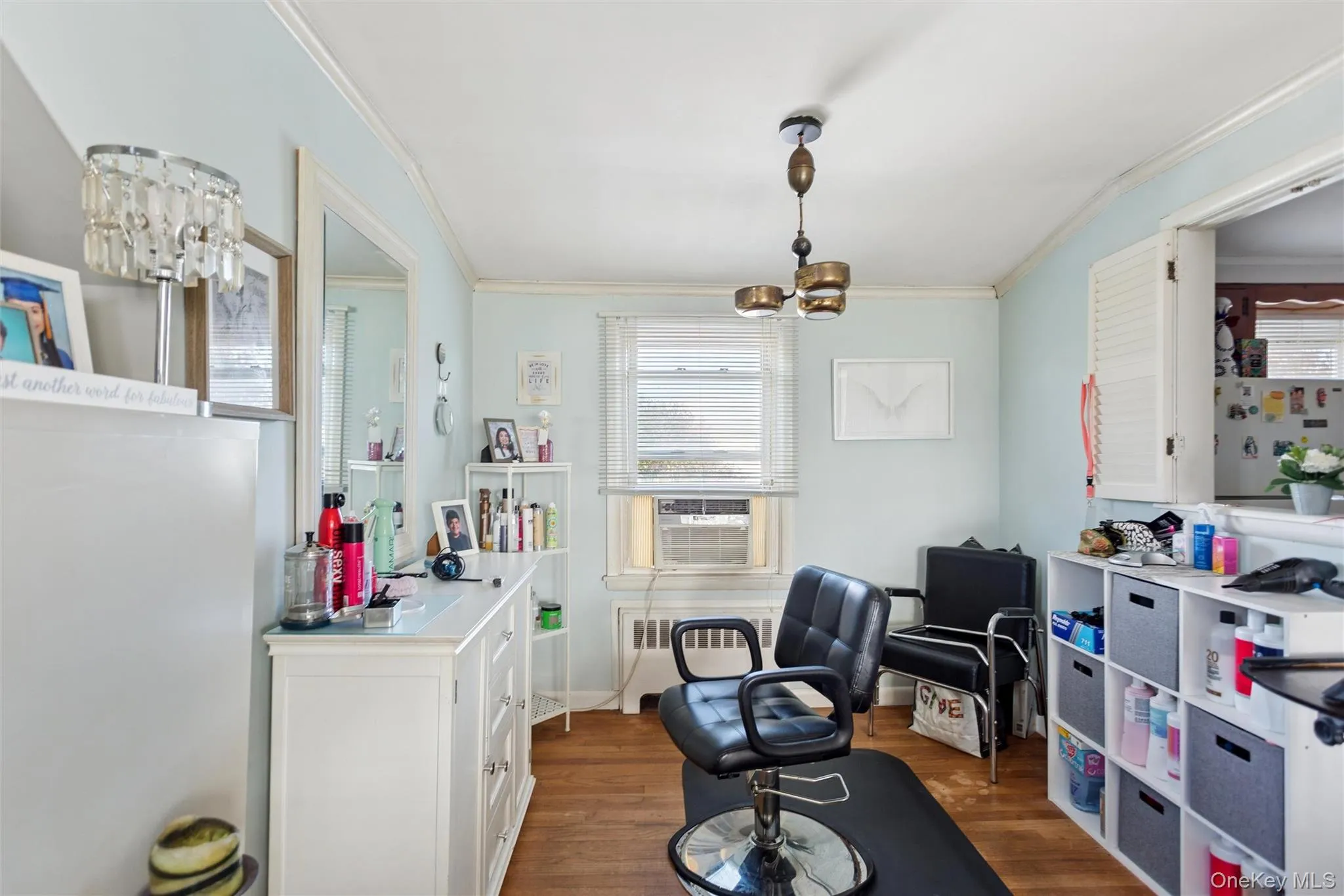 Office with a chandelier, dark wood-style flooring, ornamental molding, and plenty of natural light Office with a chandelier, dark wood-style flooring, ornamental molding, and plenty of natural light