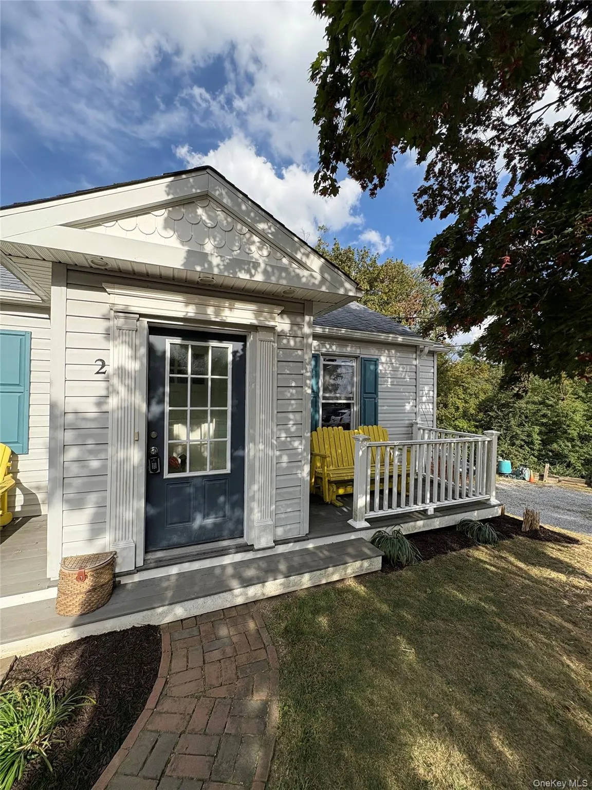 Property entrance with a lawn and a deck Property entrance with a lawn and a deck