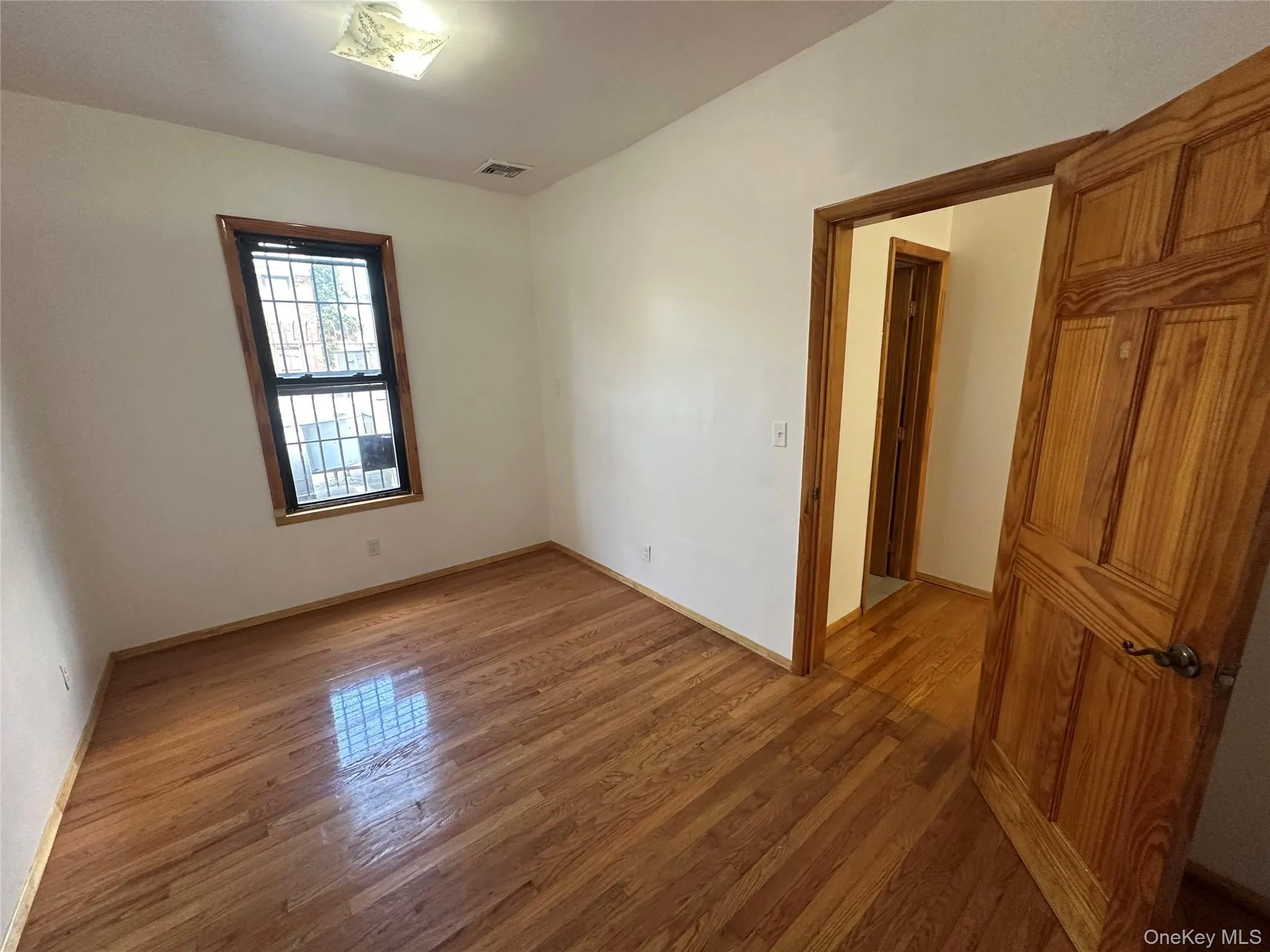 Unfurnished room featuring light wood-style floors Unfurnished room featuring light wood-style floors