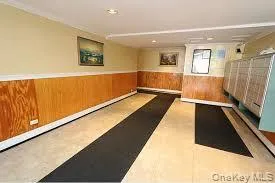 Exercise room featuring wainscoting, wood walls, recessed lighting, and mail area Exercise room featuring wainscoting, wood walls, recessed lighting, and mail area