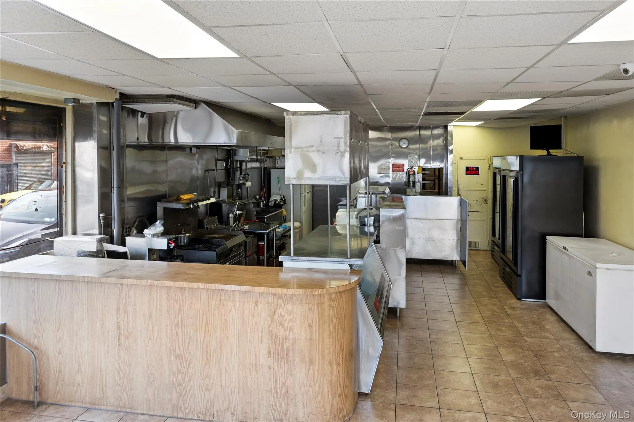 Kitchen featuring a drop ceiling and black refrigerator Kitchen featuring a drop ceiling and black refrigerator