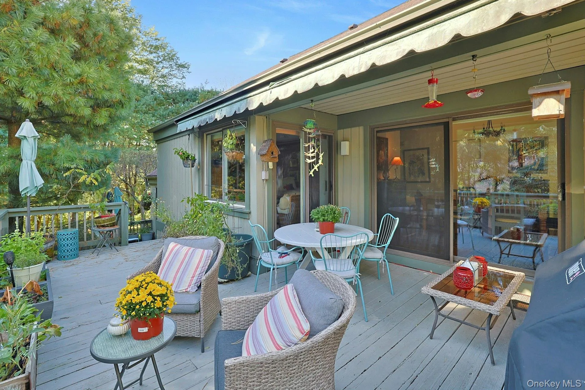 Wooden terrace with outdoor dining space with electric powered awning. Wooden terrace with outdoor dining space with electric powered awning.