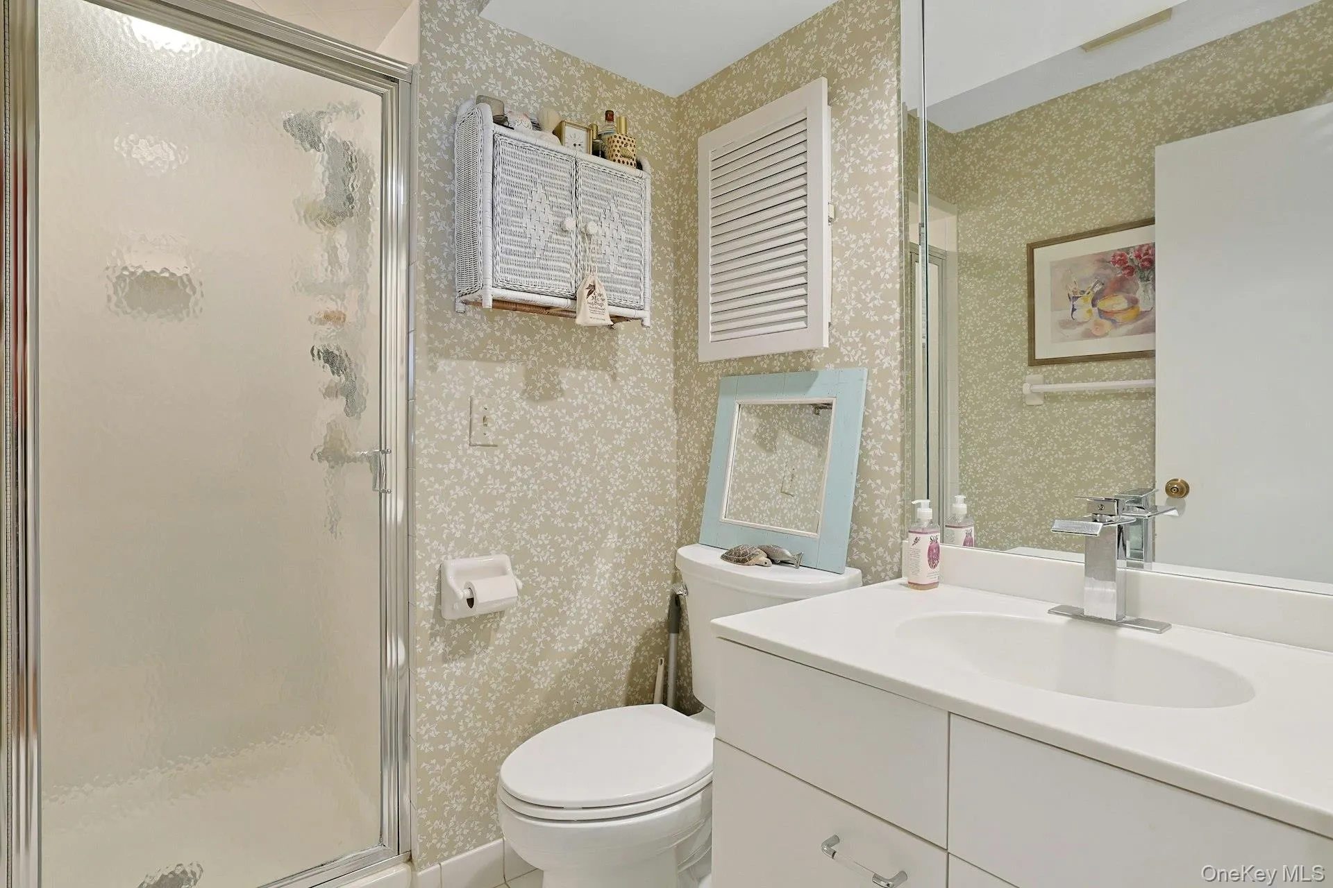 Full bath with wallpapered walls, a stall shower, and vanity Full bath with wallpapered walls, a stall shower, and vanity
