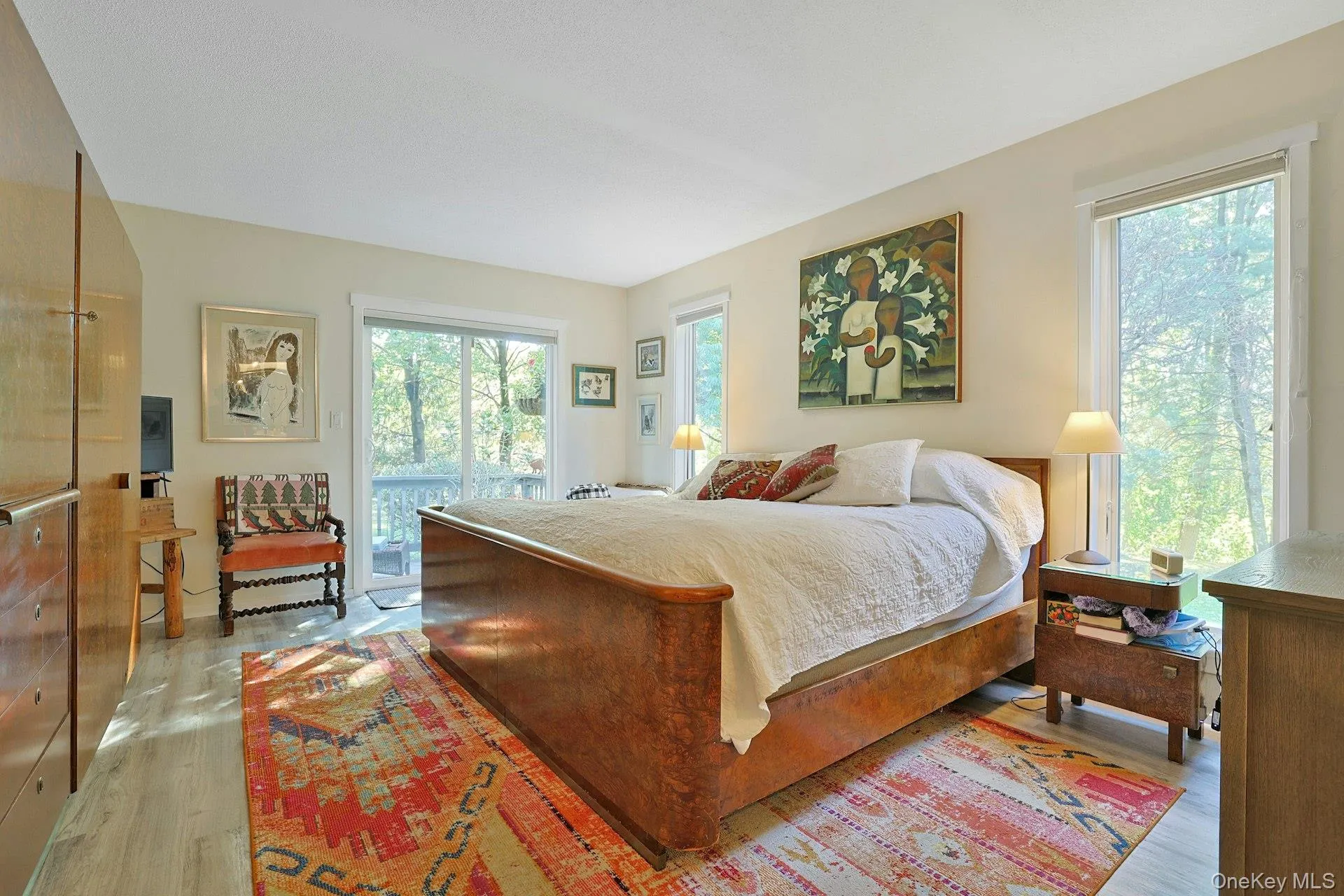 Primary bedroom with access to private deck. Primary bedroom with access to private deck.