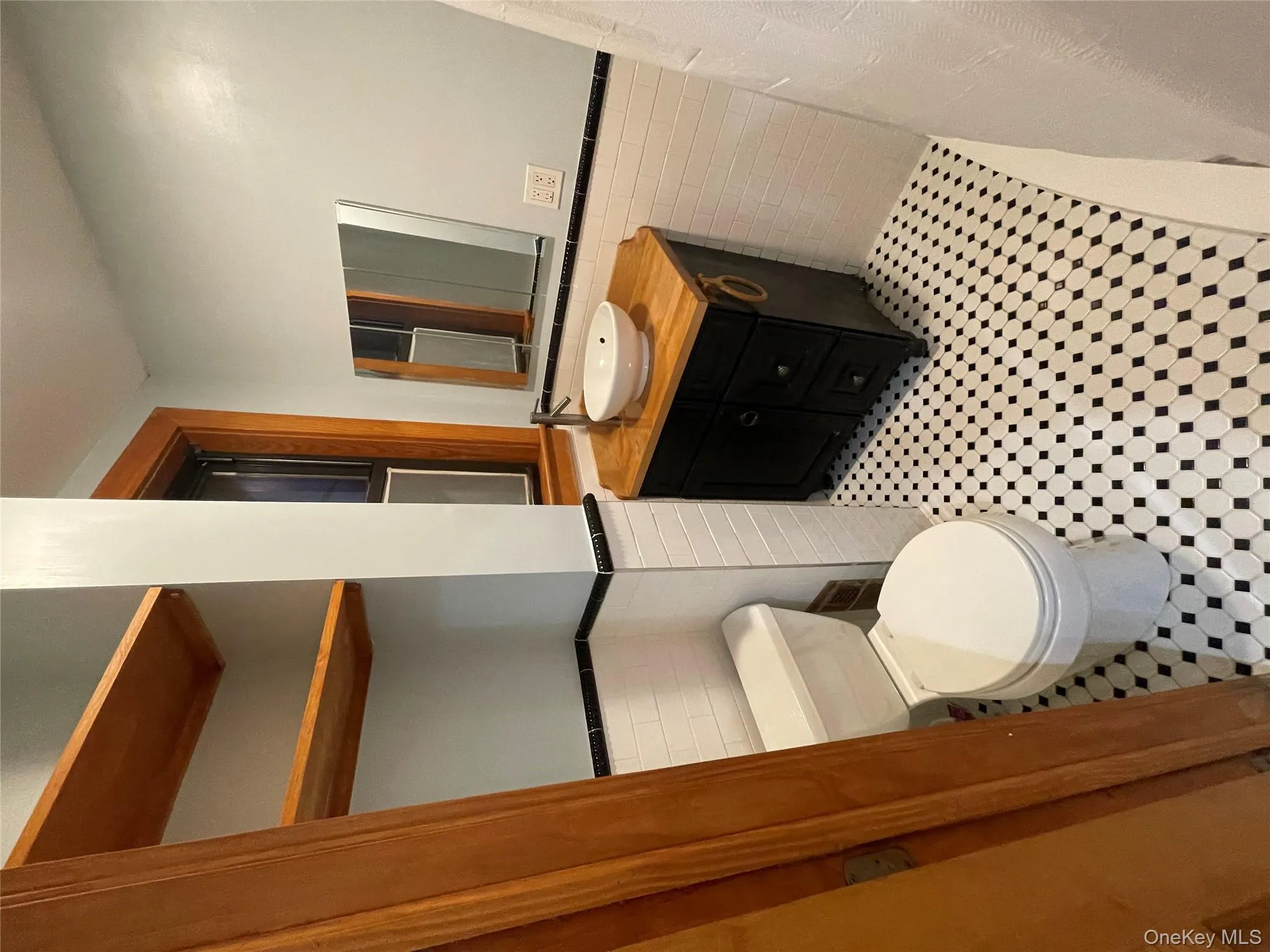 Bathroom featuring a wainscoted wall, tile walls, and vanity Bathroom featuring a wainscoted wall, tile walls, and vanity