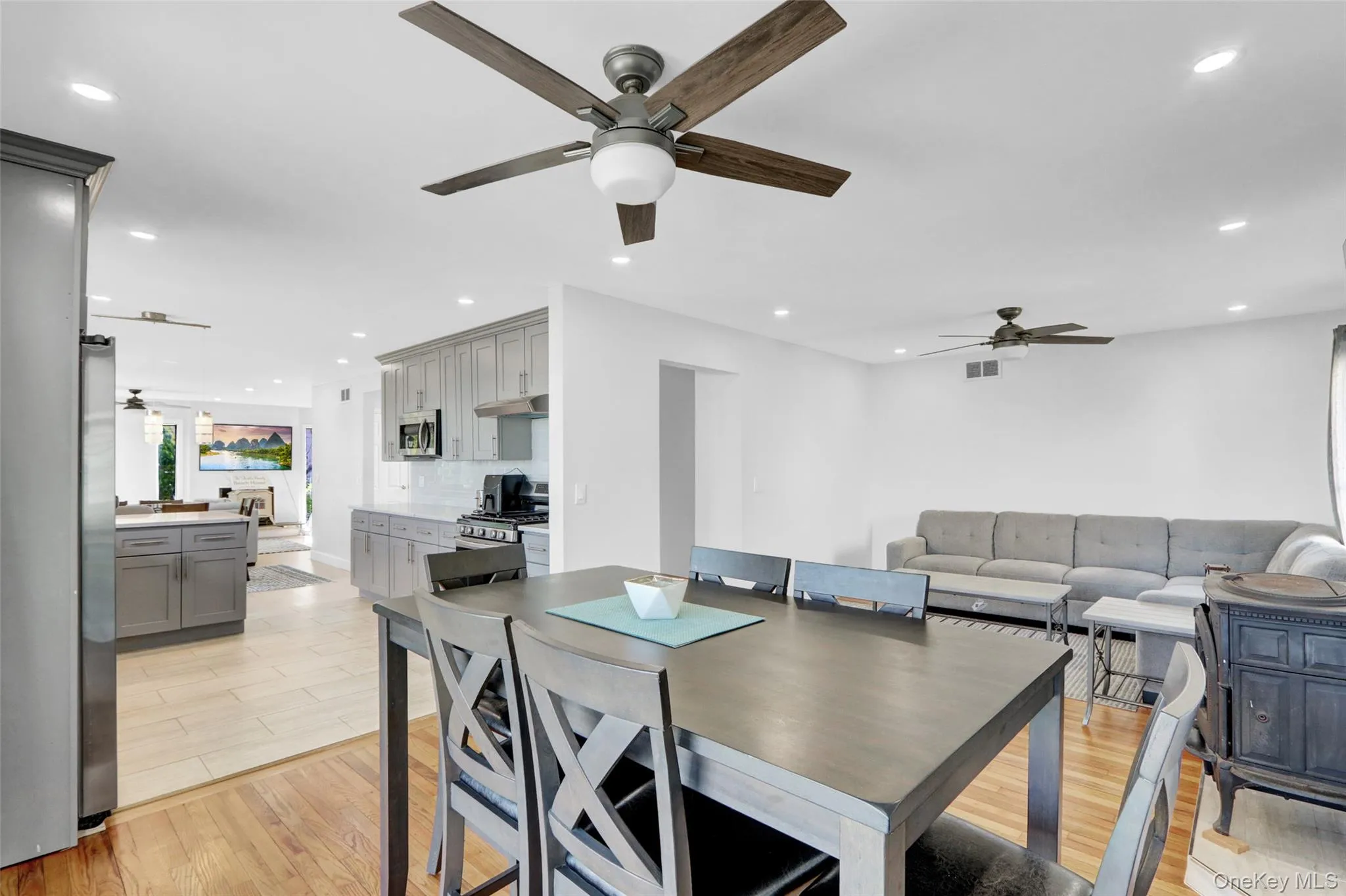 Dining room featuring light wood-type flooring, ceiling fan, and recessed lighting Dining room featuring light wood-type flooring, ceiling fan, and recessed lighting