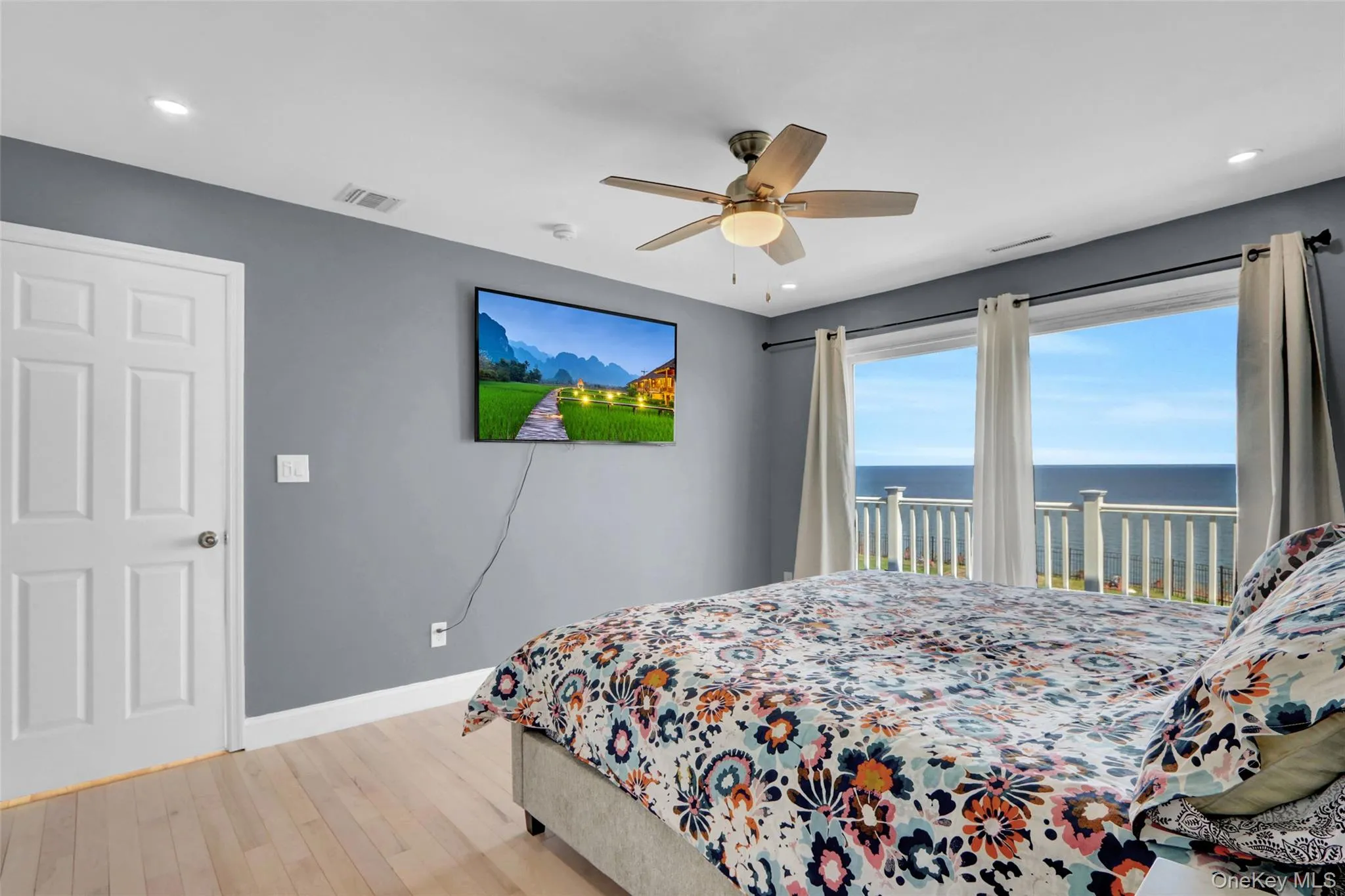 Bedroom featuring light wood-type flooring, access to exterior, a ceiling fan, and recessed lighting Bedroom featuring light wood-type flooring, access to exterior, a ceiling fan, and recessed lighting