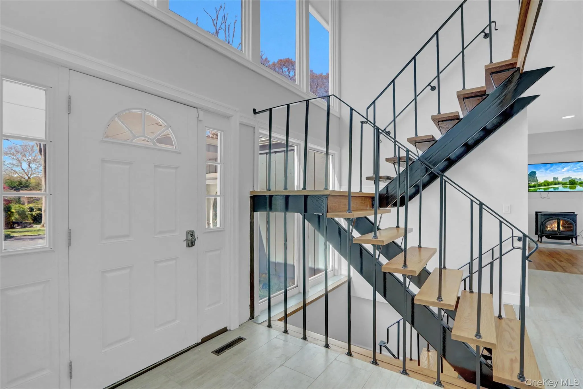 Entrance foyer with stairway and a high ceiling Entrance foyer with stairway and a high ceiling