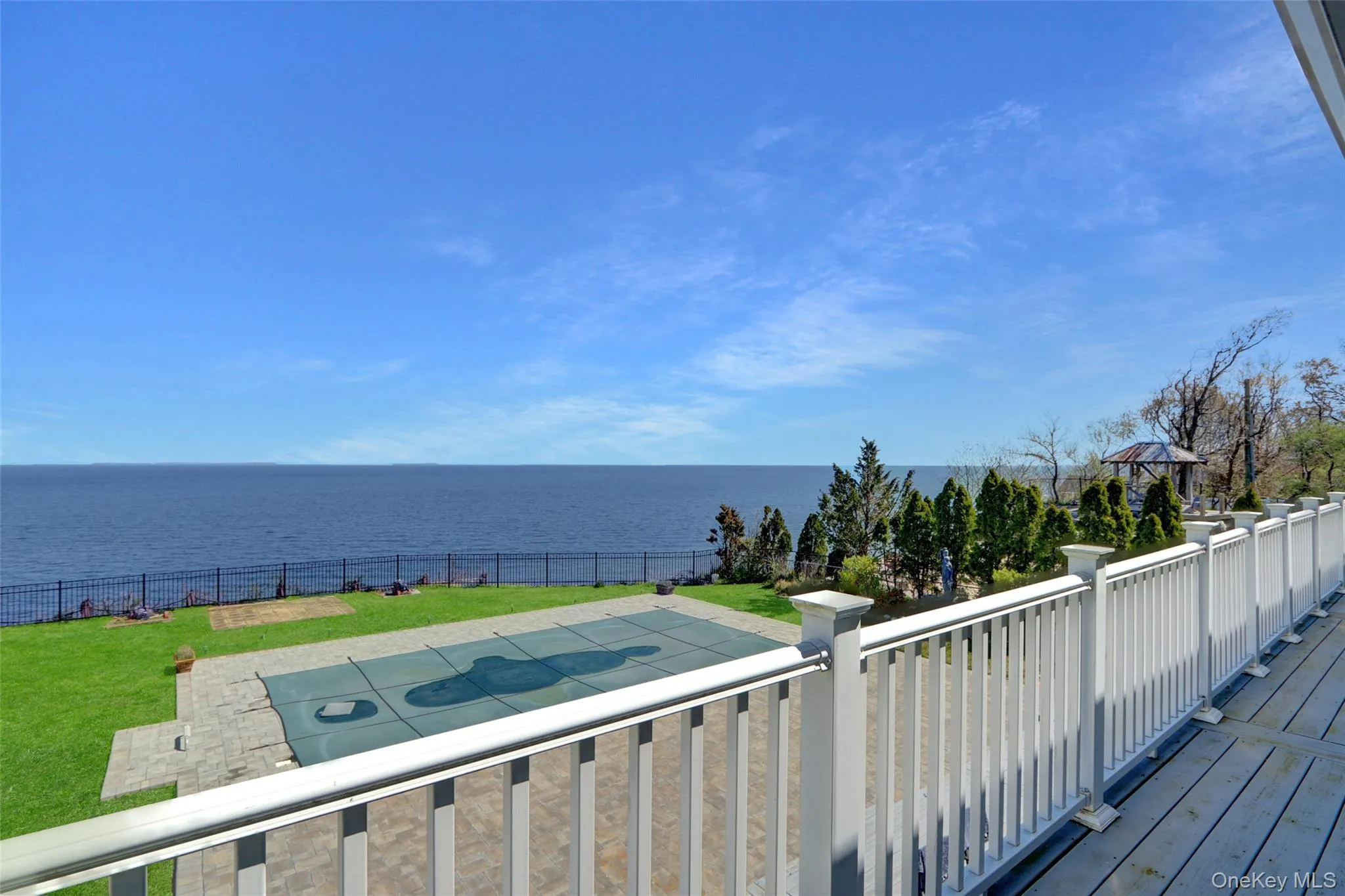 Wooden deck featuring a water view and a fenced backyard Wooden deck featuring a water view and a fenced backyard