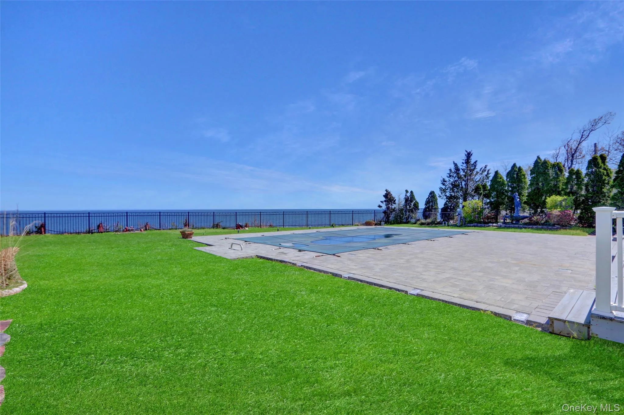 View of property's community with a fenced backyard and a pool View of property's community with a fenced backyard and a pool