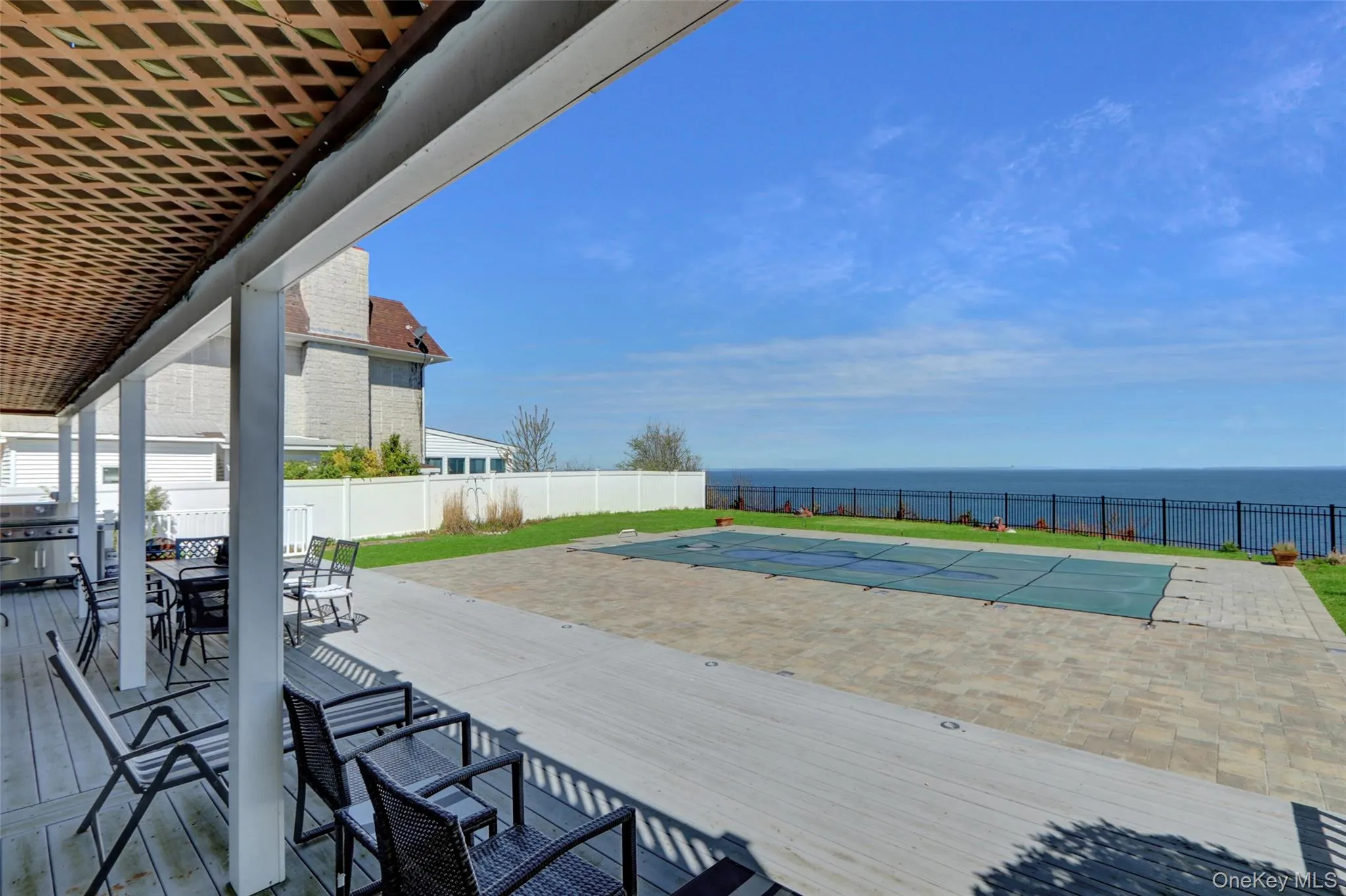 Deck with a patio area, a fenced backyard, a water view, and outdoor dining area Deck with a patio area, a fenced backyard, a water view, and outdoor dining area