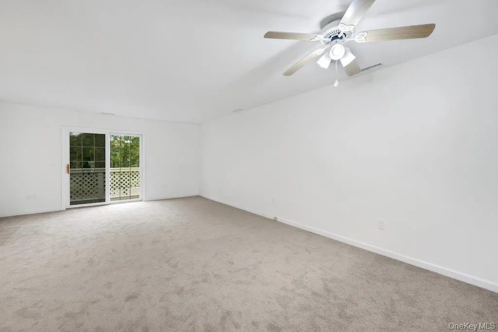 Unfurnished room with carpet floors and ceiling fan Unfurnished room with carpet floors and ceiling fan