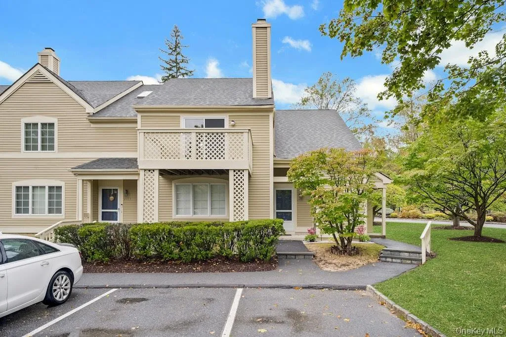 View of property featuring uncovered parking View of property featuring uncovered parking