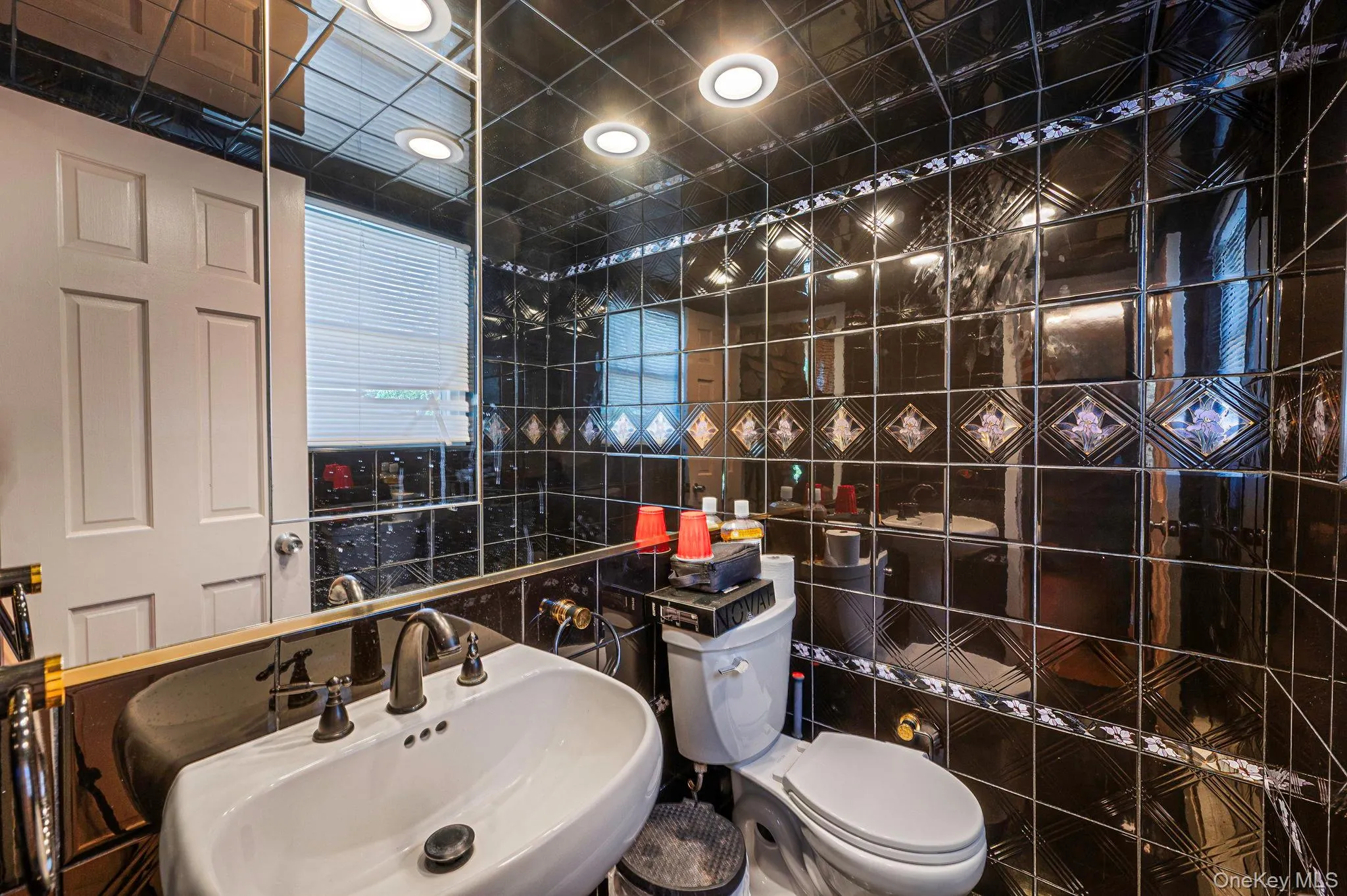 Half bath with a sink and tile walls Half bath with a sink and tile walls