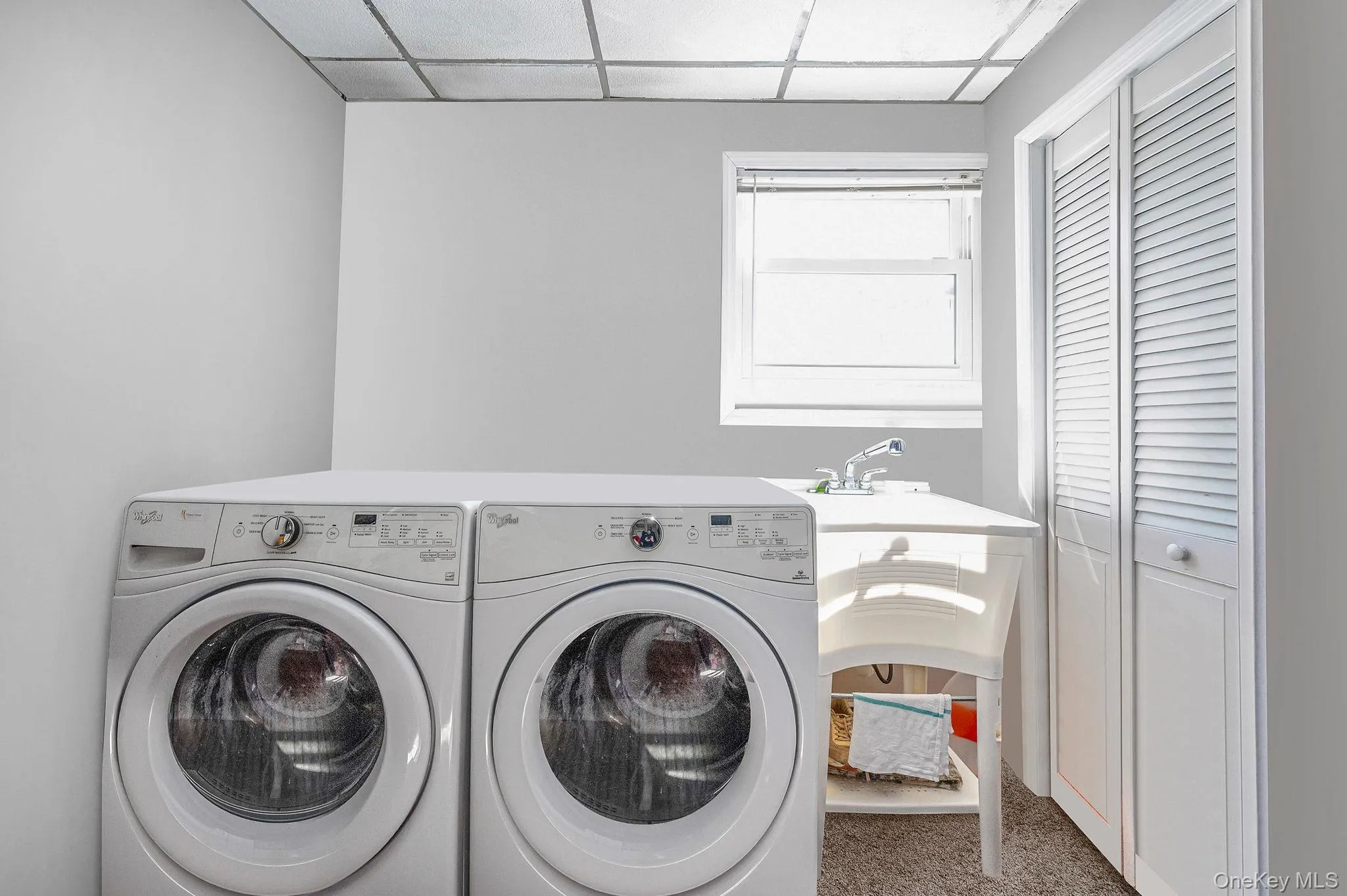 Laundry room featuring a drop ceiling and washing machine and dryer Laundry room featuring a drop ceiling and washing machine and dryer
