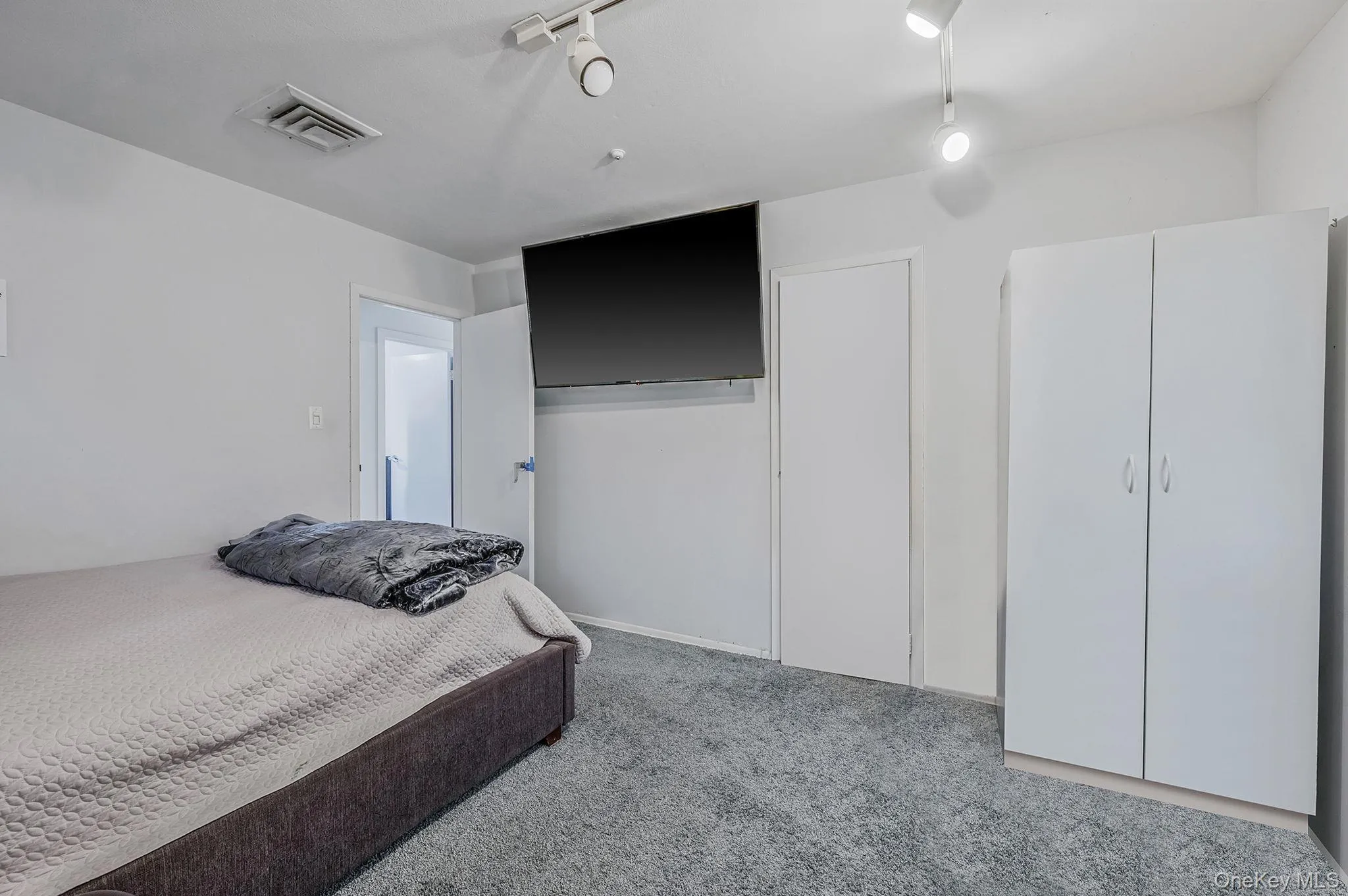 Bedroom featuring light colored carpet Bedroom featuring light colored carpet