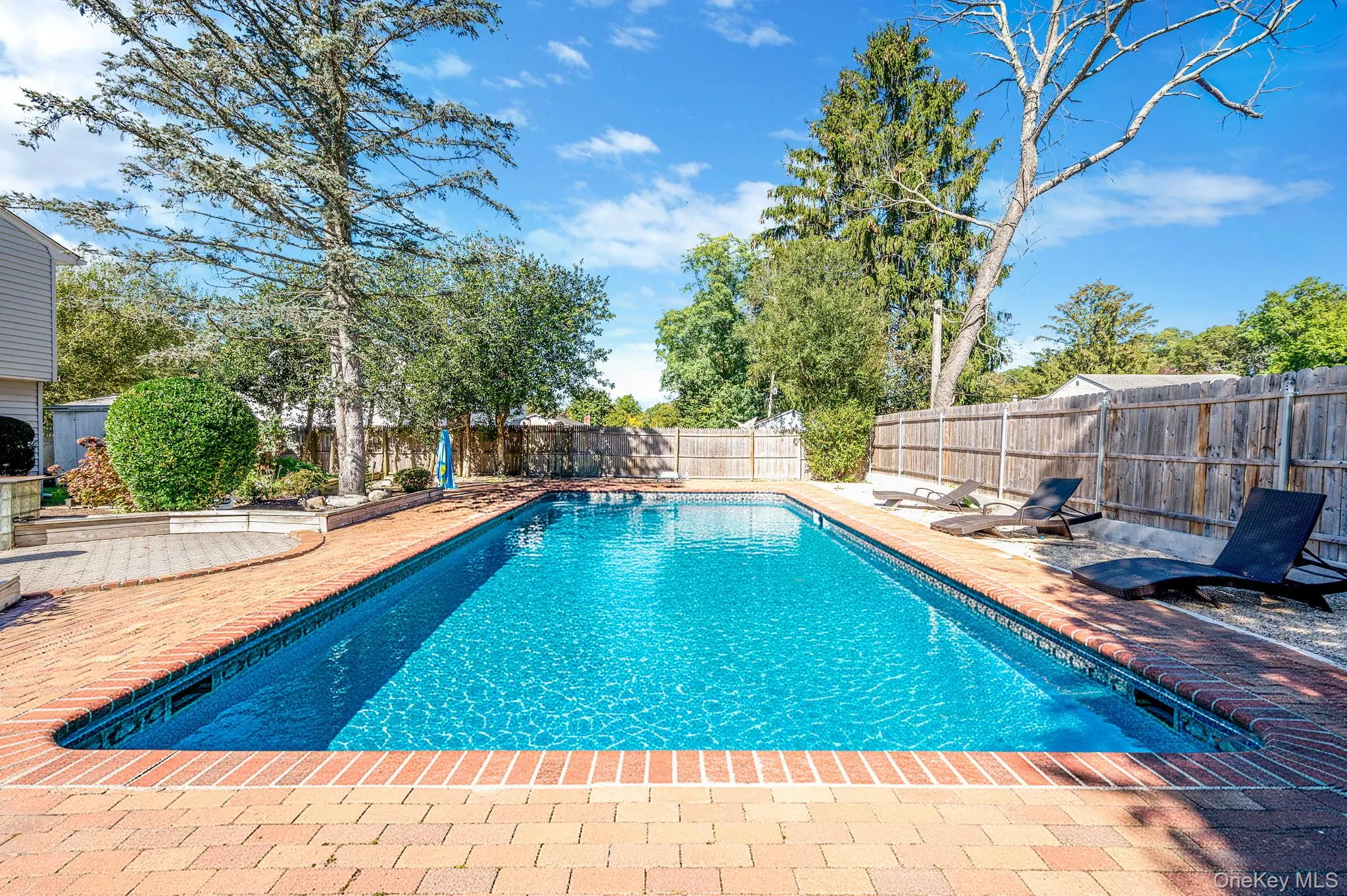 View of pool featuring a patio area and a fenced backyard View of pool featuring a patio area and a fenced backyard
