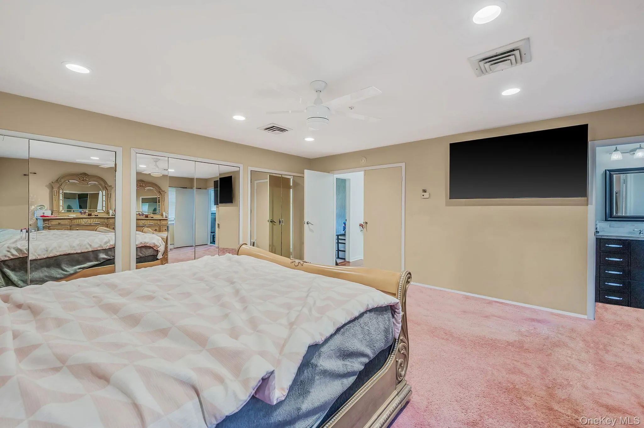 Carpeted bedroom featuring two closets, ceiling fan, and recessed lighting Carpeted bedroom featuring two closets, ceiling fan, and recessed lighting