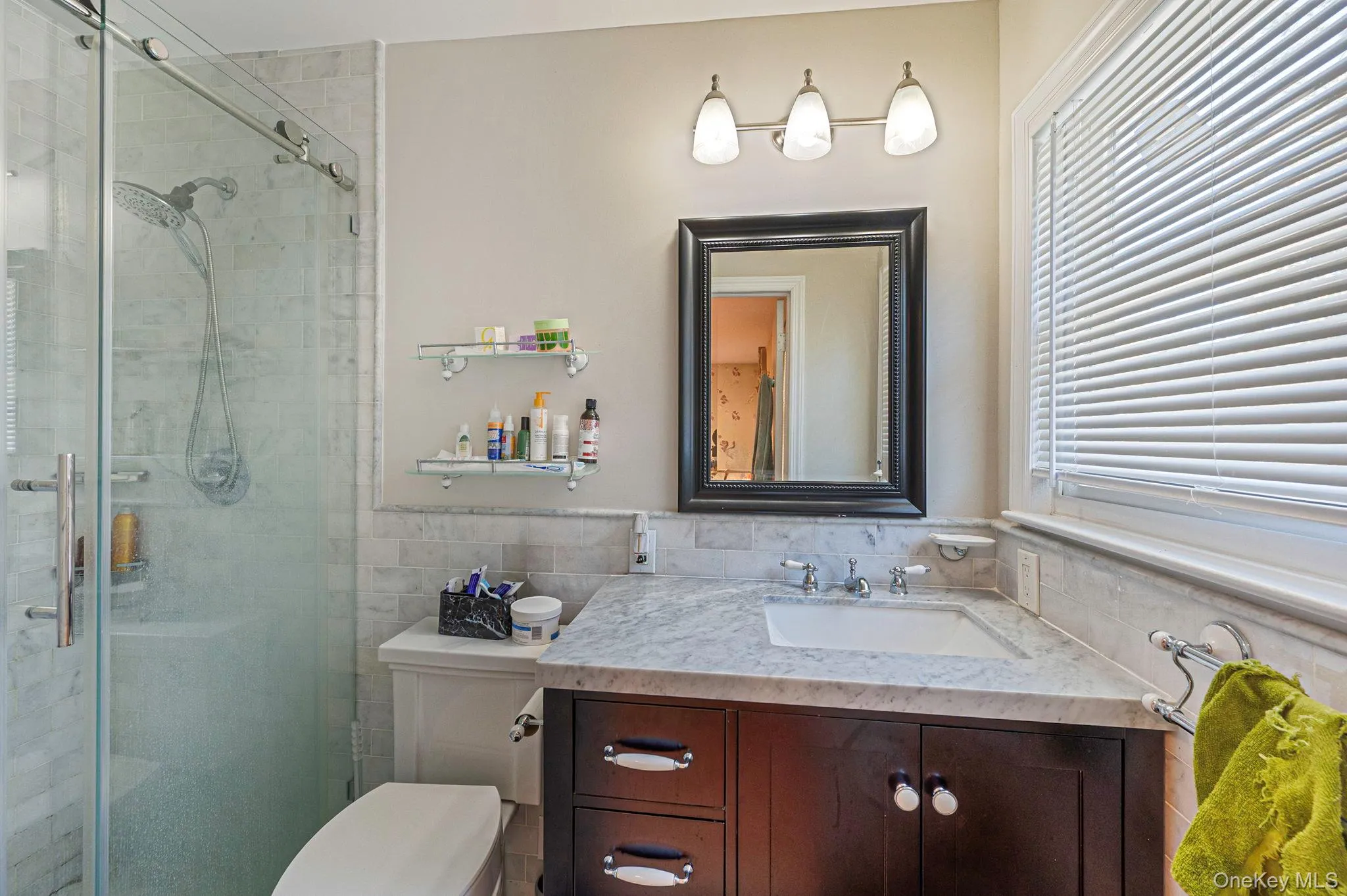 Full bathroom featuring vanity, a shower stall, and tile walls Full bathroom featuring vanity, a shower stall, and tile walls